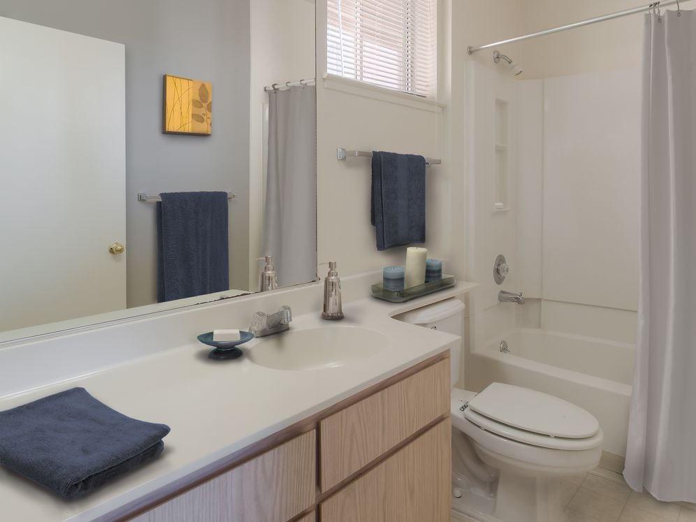 Classic Package I bath with light oak cabinetry, white laminate countertops, and hard surface flooring