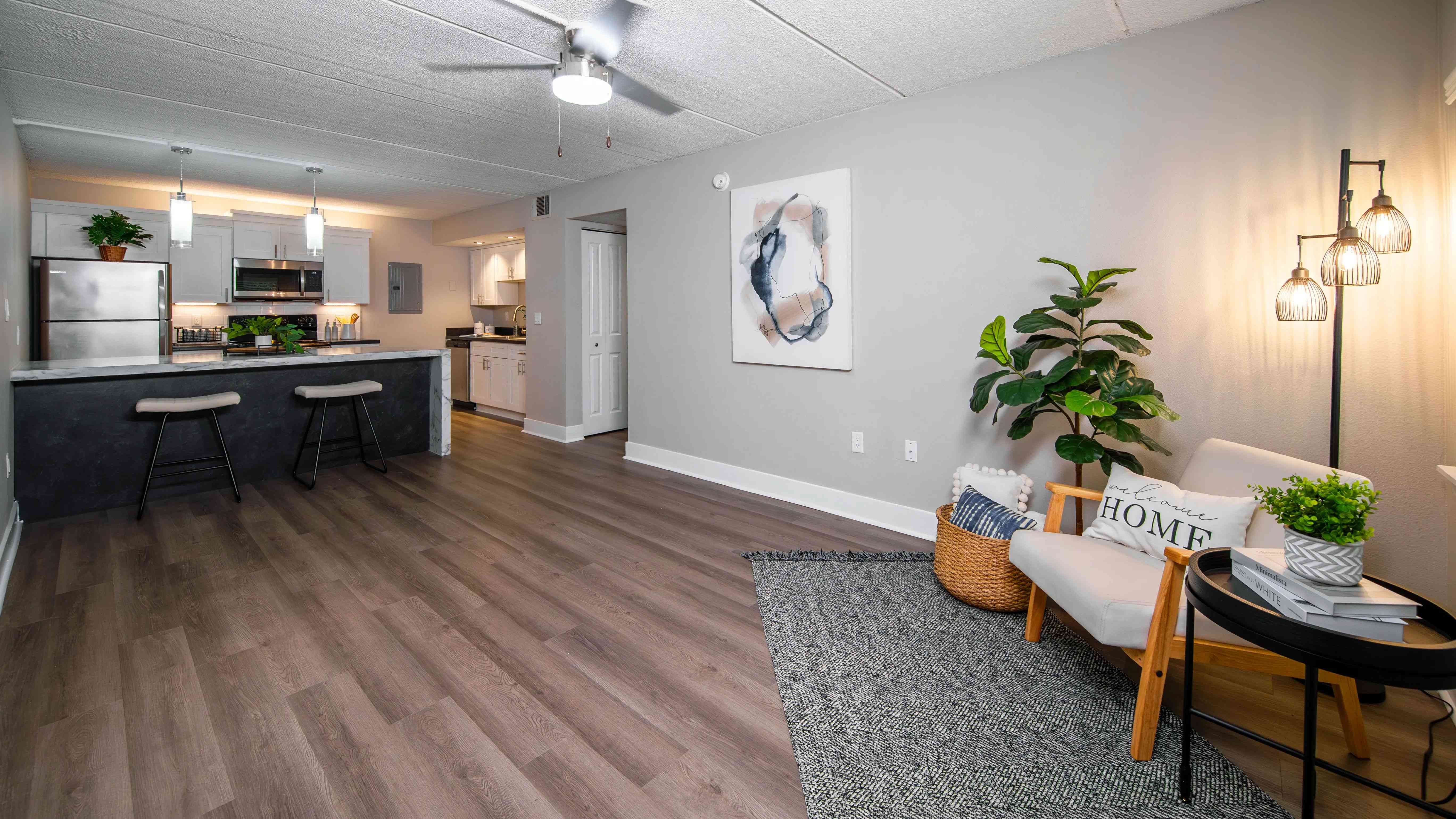 Experience the perfect blend of style and comfort in our open-concept floor plan layouts featuring wood-style flooring.