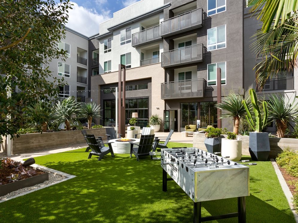 Building B courtyard lounge with gaming, fireplace and lounge seating