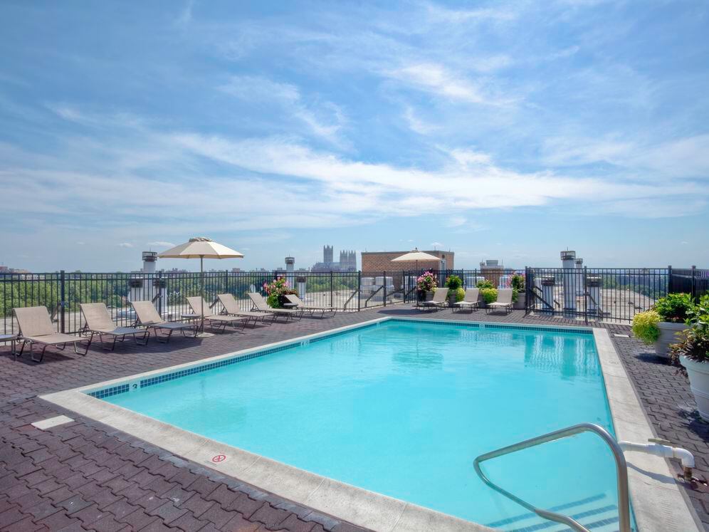 Rooftop swimming pool and sundeck with lounge seating