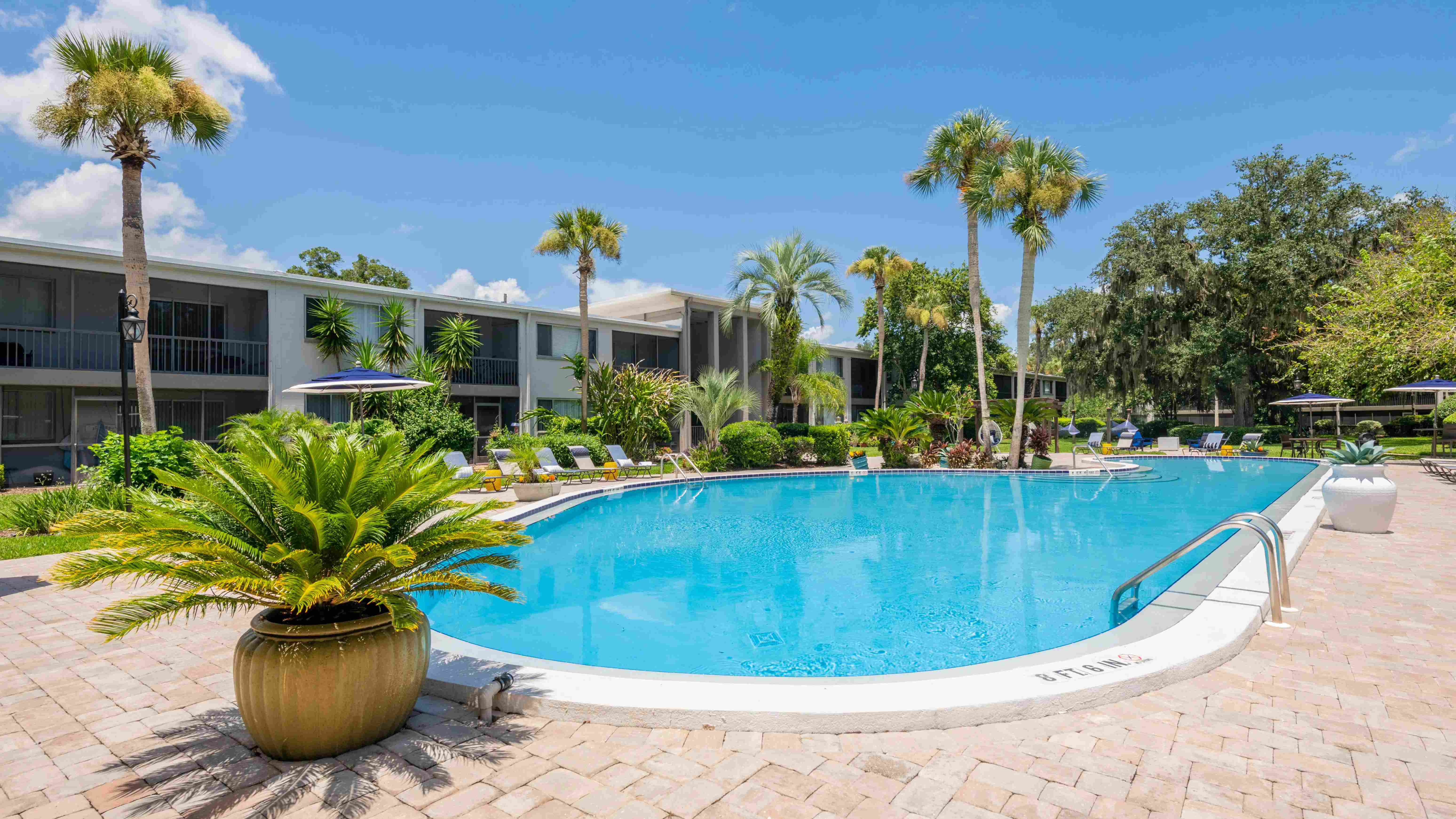 Witness the allure of our radiant resort-style pool, embraced by lush greenery and a sun-drenched, expansive sundeck.