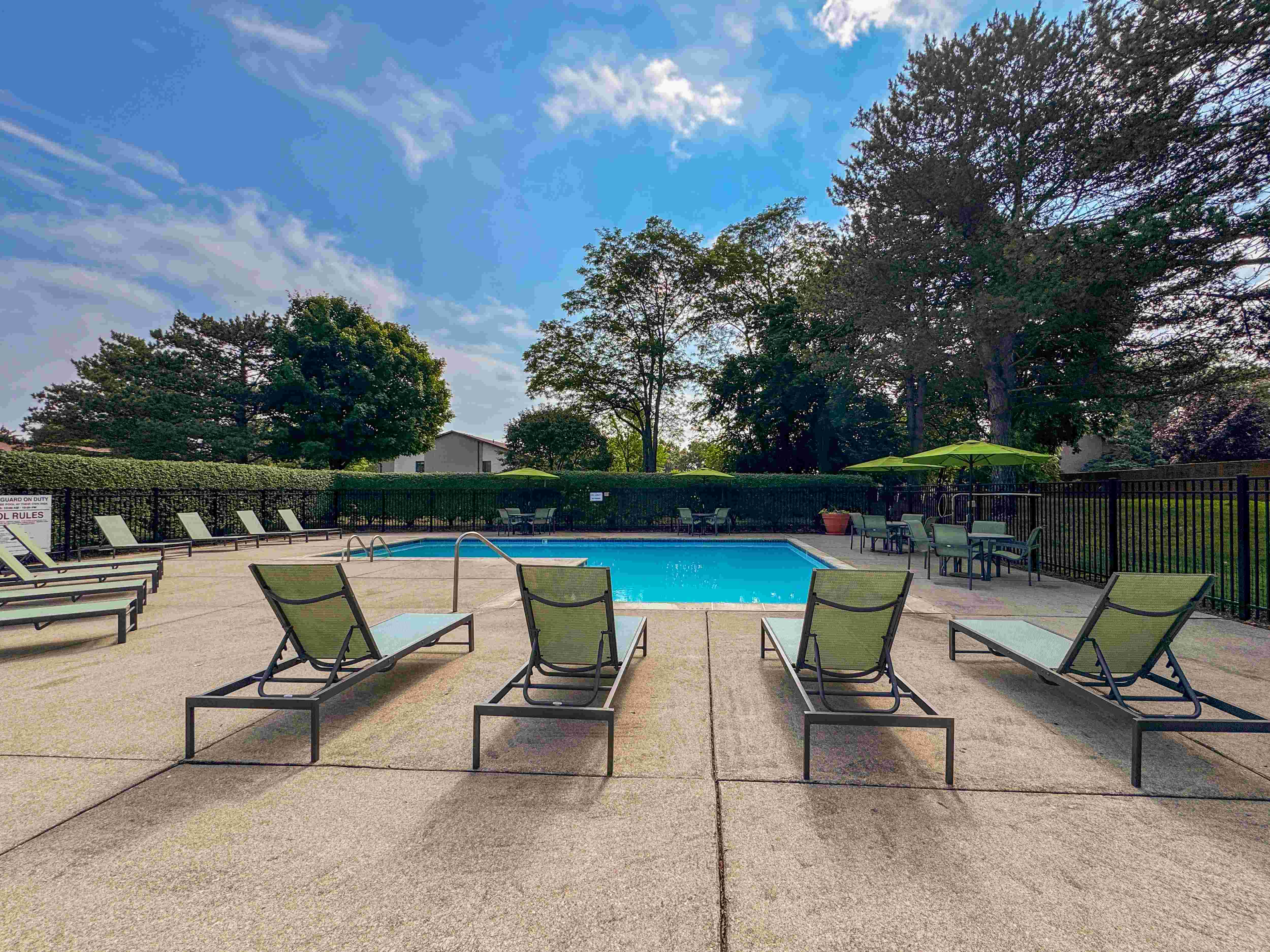 Swimming pool with sundeck at Woodland Villa Apartments in Westland, MI.