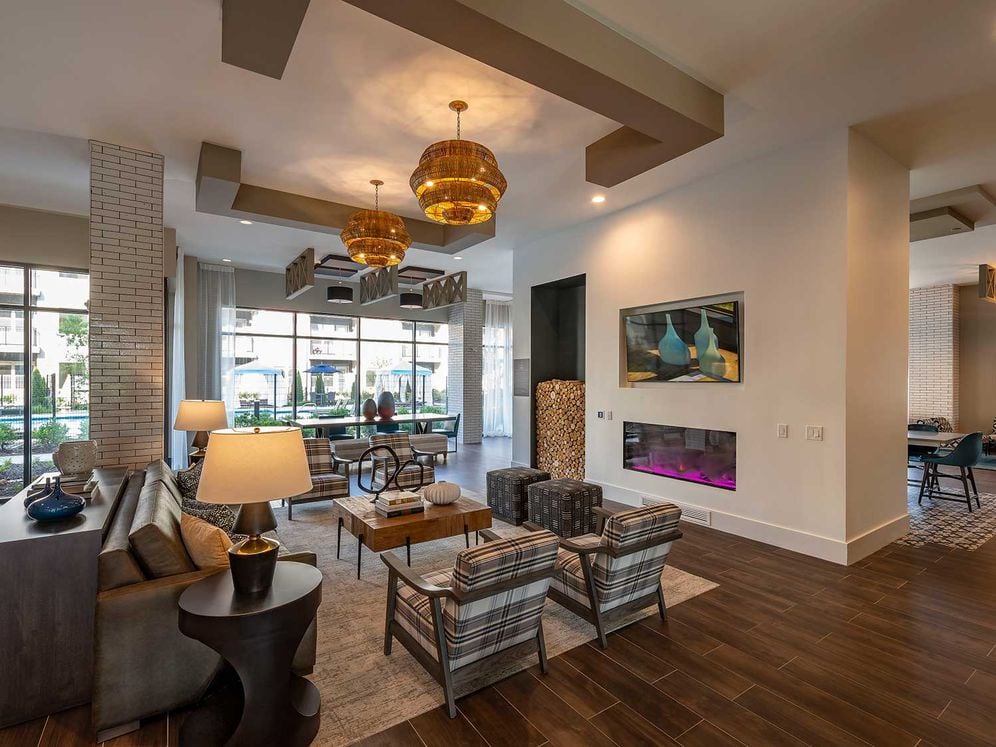 East building resident lounge with lounge seating, fireplace, and flat screen television