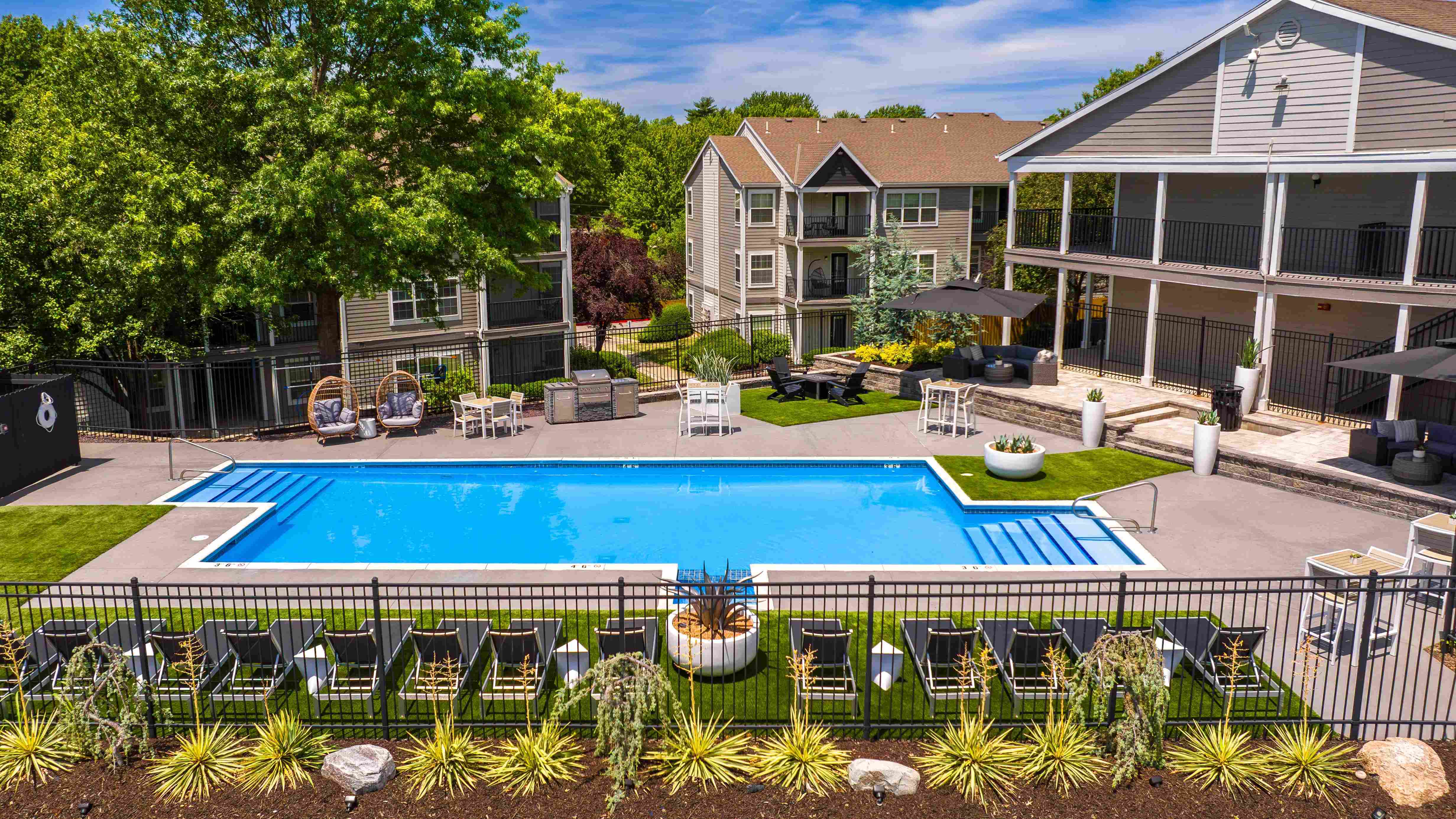 Relax and unwind at our inviting poolside retreat, featuring comfortable lounge chairs, cozy seating areas, and beautifully landscaped surroundings for the perfect summer day.