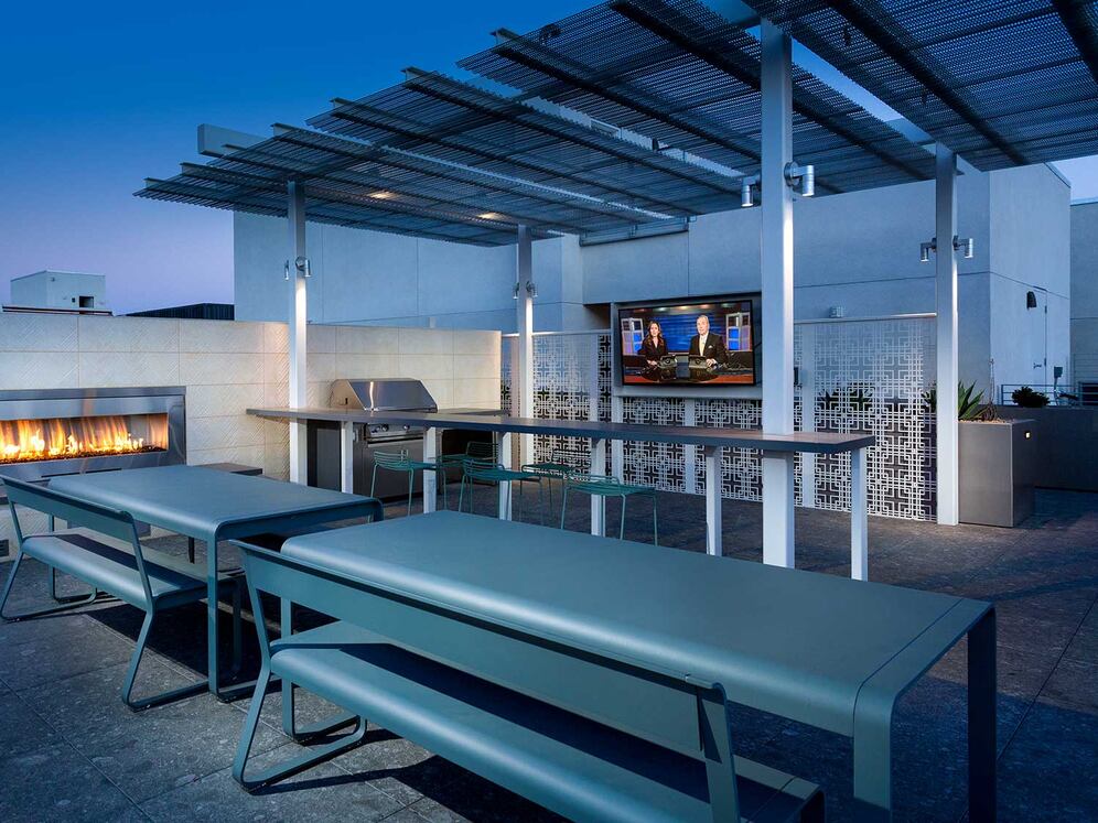 Roofdeck with outdoor fireplace, barbeque grills, flatscreen television and seating
