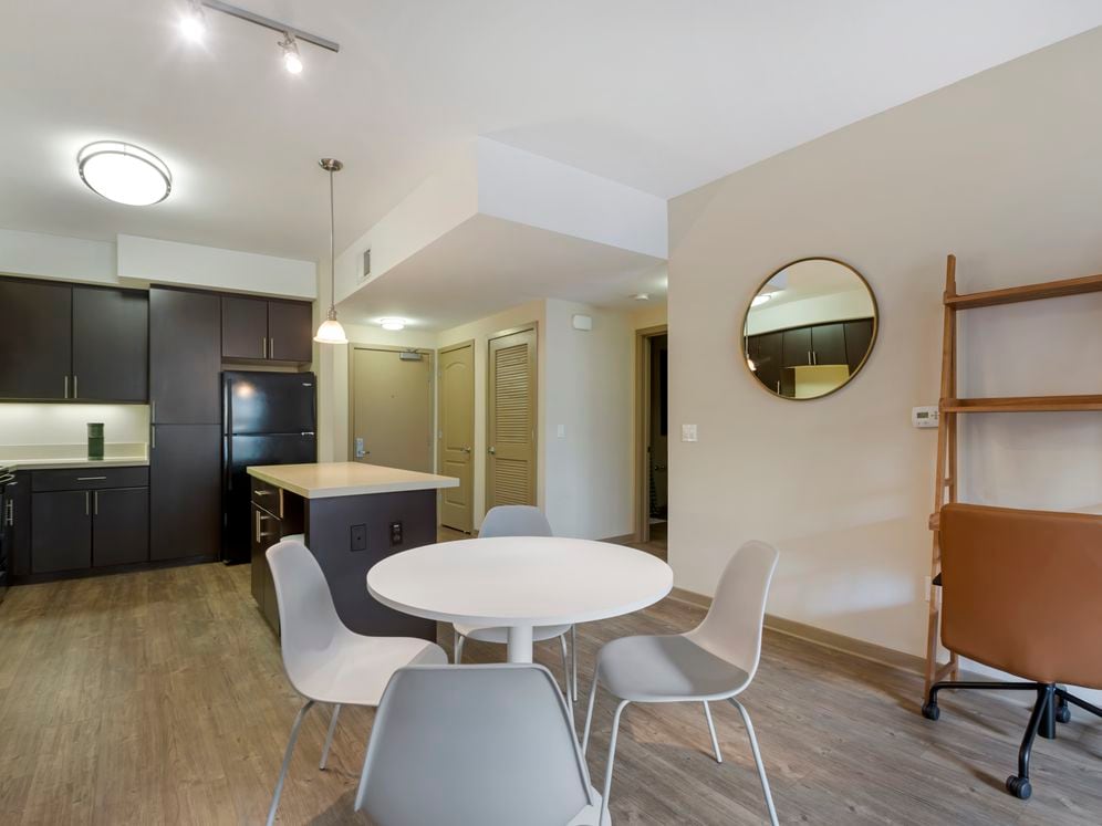 Furnished+ apartment homes include a dining set (Representative Image – exact items and style of furnishings may vary)