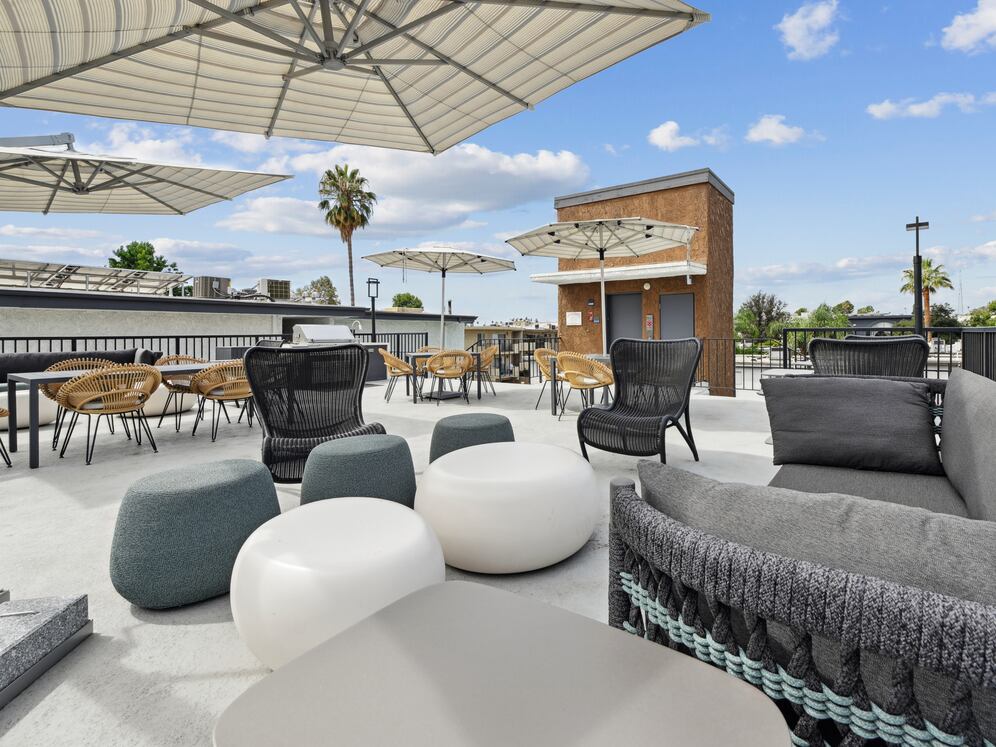 Rooftop terrace with BBQ grills, lounge seating, and picnic areas