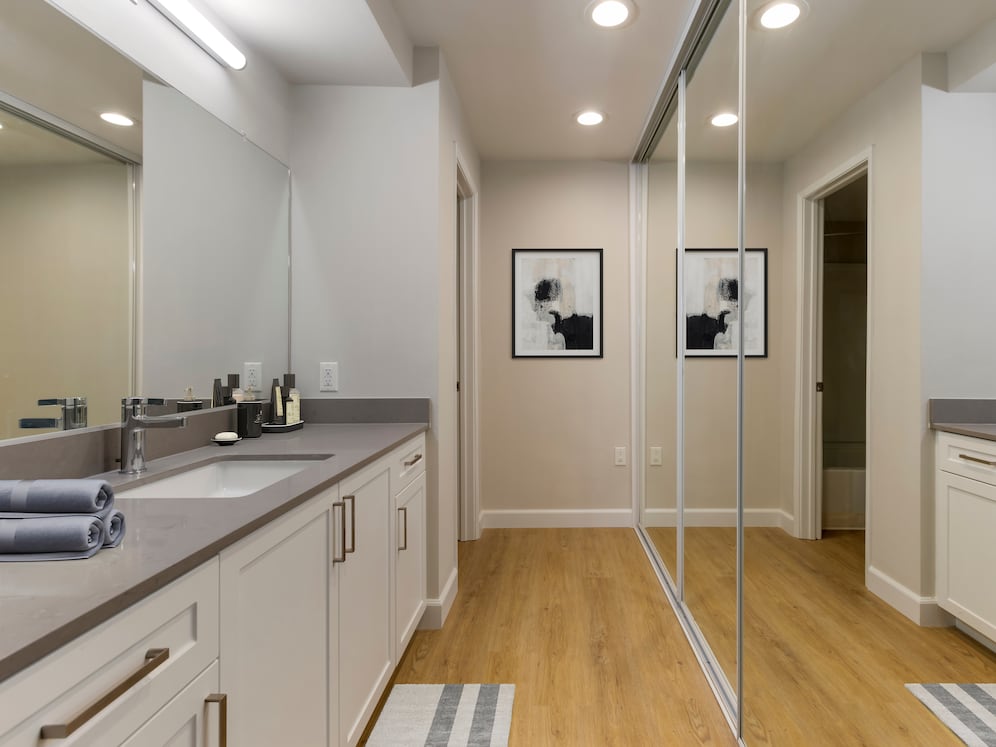 Bath with white cabinetry, grey quartz countertops, and hard surface flooring (Select Home)