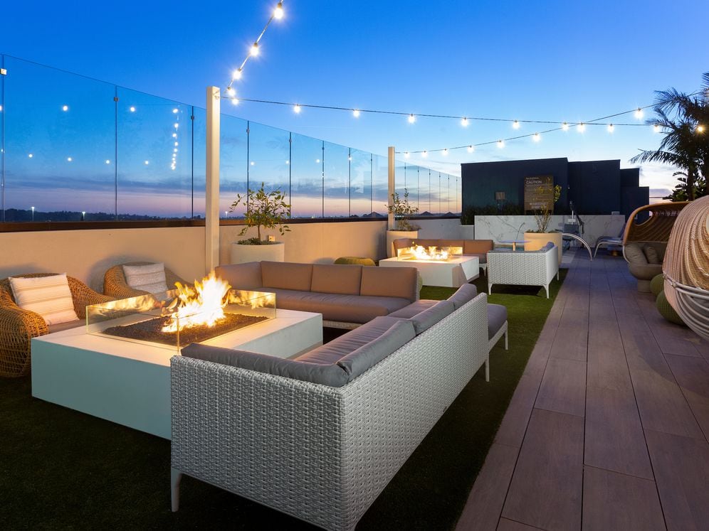 Building A rooftop lounge with fireplace and lounge seating