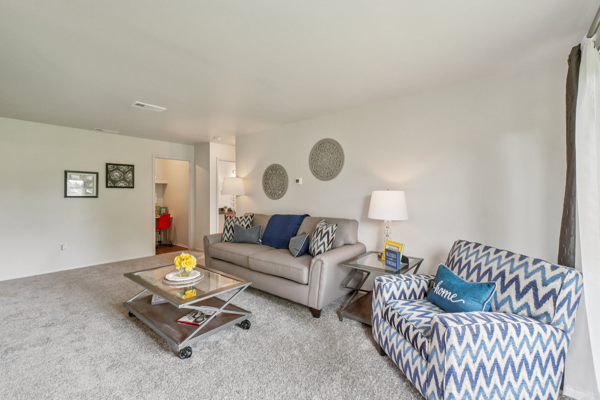 Elevated living room and private patio or balcony at Drawbridge Apartments in Harrison Township, MI.