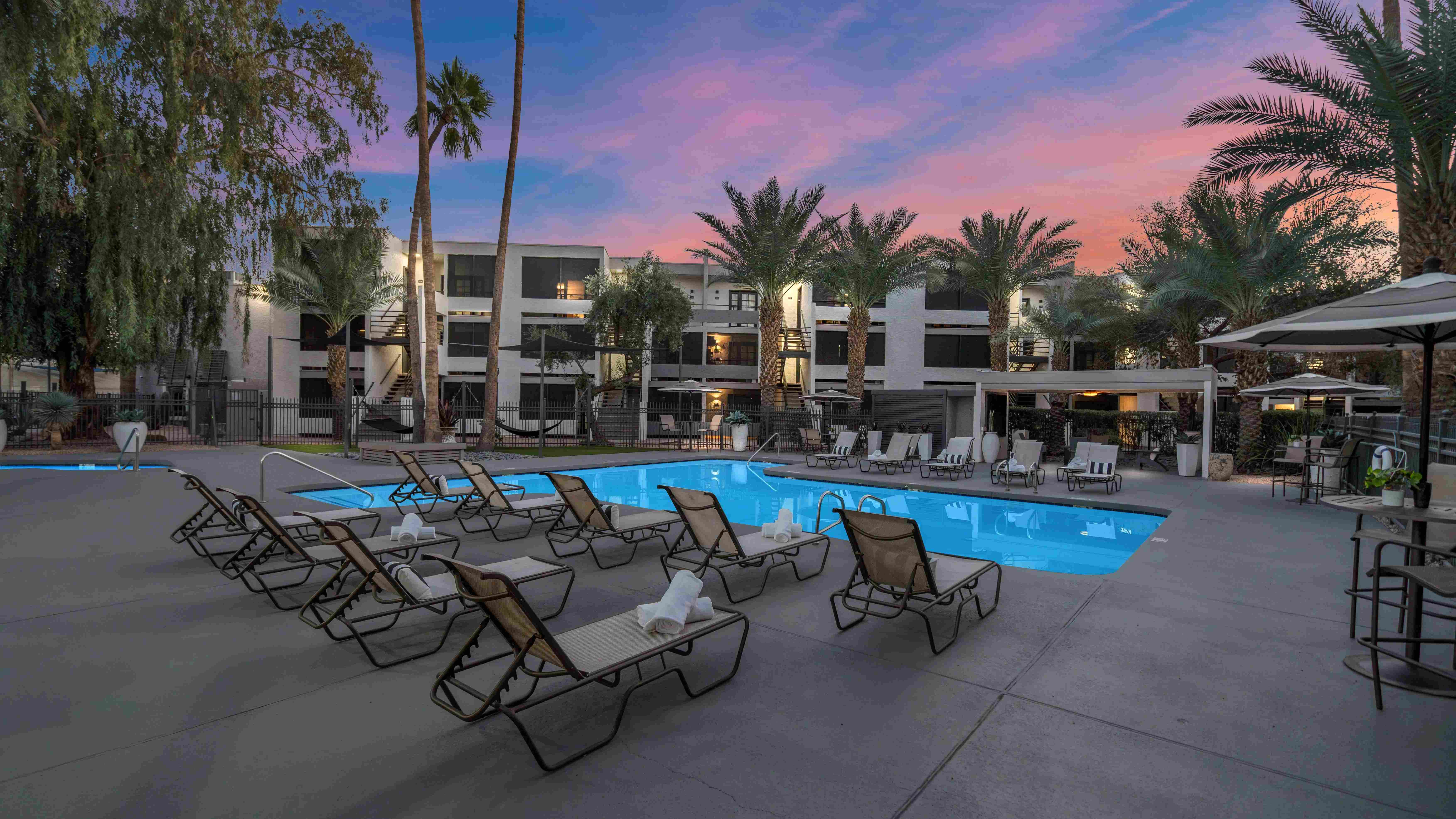 Experience Arizona twilight where vibrant skies reflect off crystal clear waters. Unwind in style with hightop seating, shaded umbrellas, and the perfect evening ambiance.