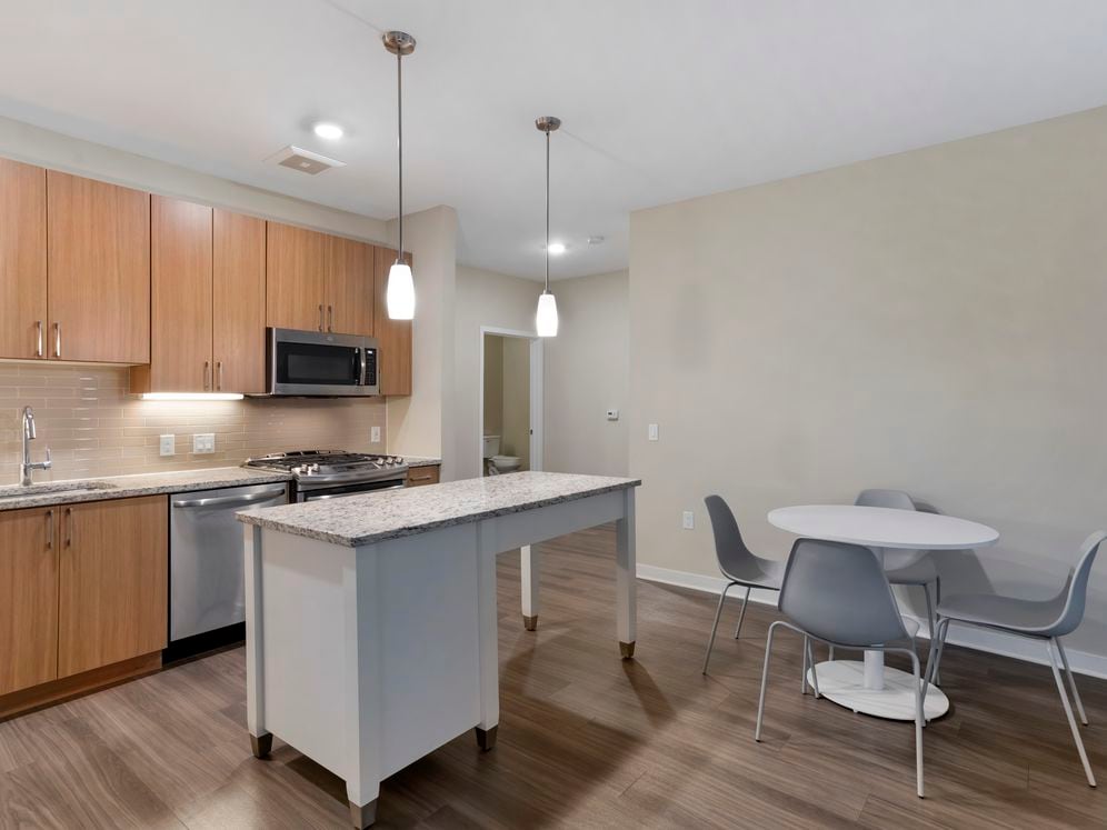 Furnished+ apartment homes include a dining set (Representative Image – exact items and style of furnishings may vary)