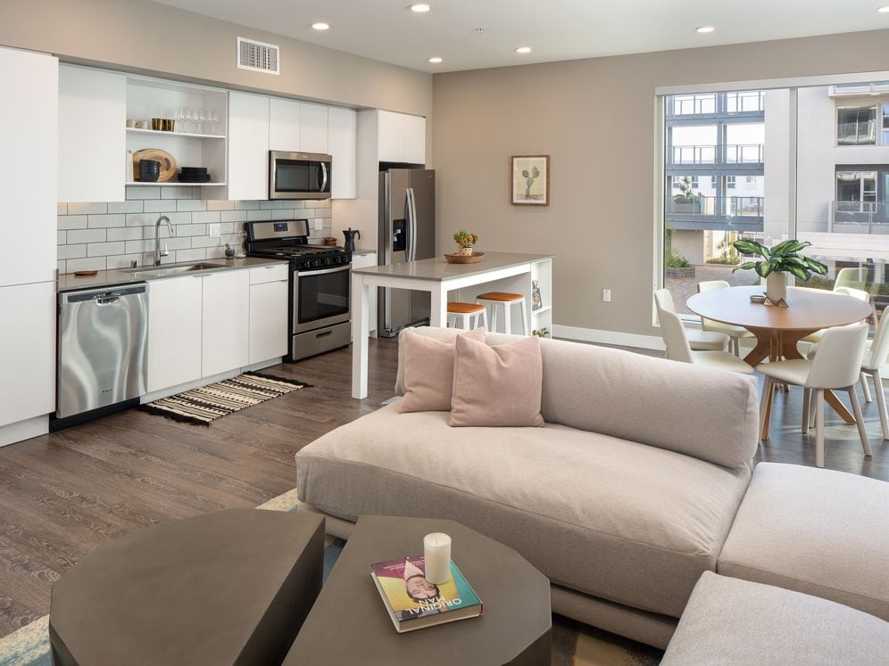 Open concept kitchen and living area with hard surface flooring