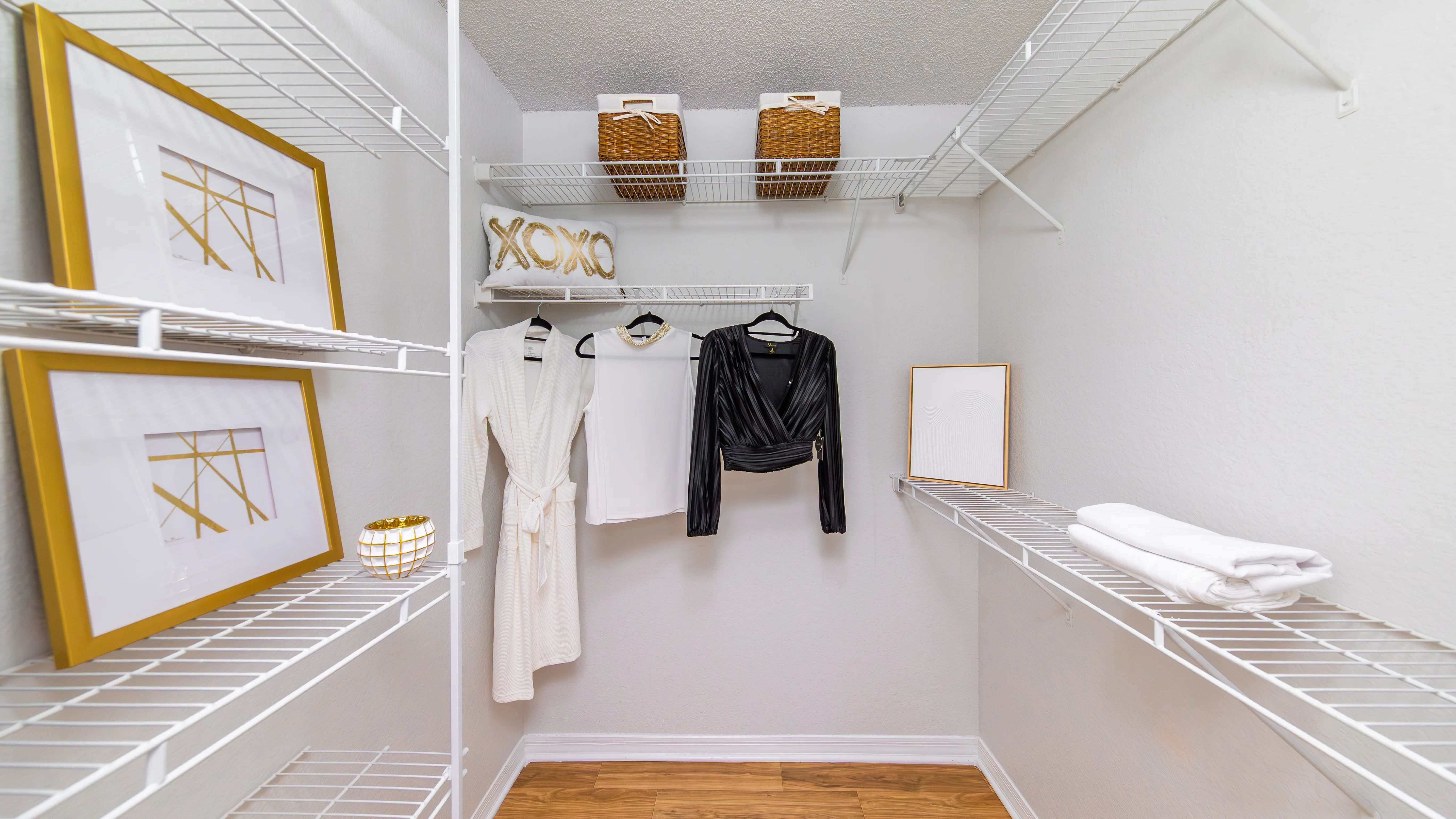 Stay effortlessly organized with this stylish walk-in closet, featuring built-in shelving and plenty of space to organize your wardrobe.