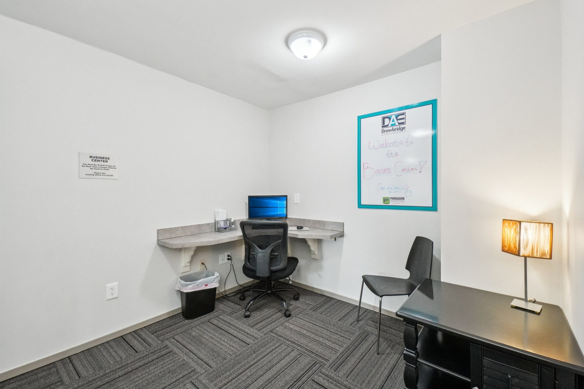 Modern business center with computer at Drawbridge Apartments in Harrison Township, MI.