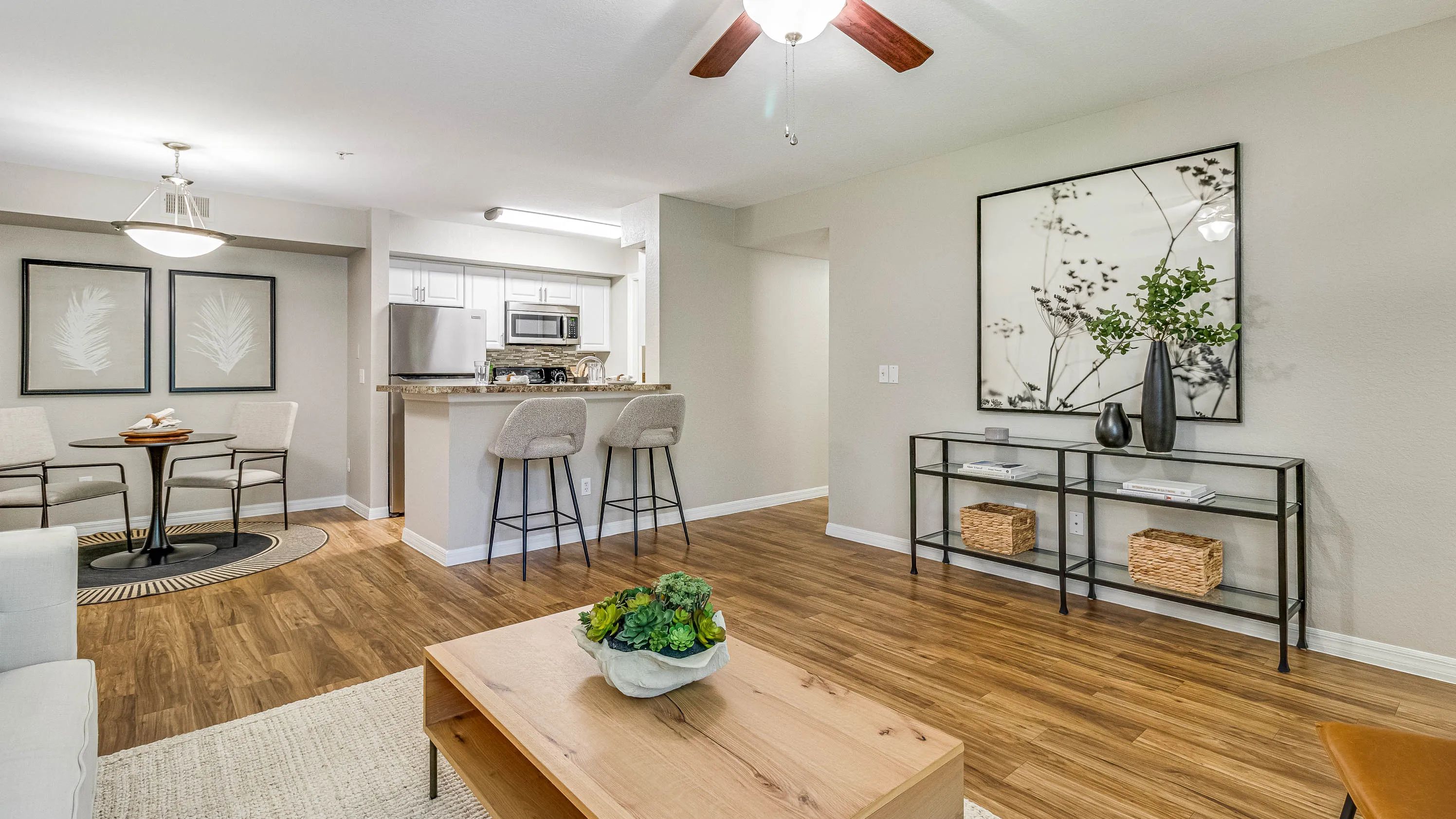 Embrace a spacious, open-concept living exuding timeless elegance with warm wood-like flooring.