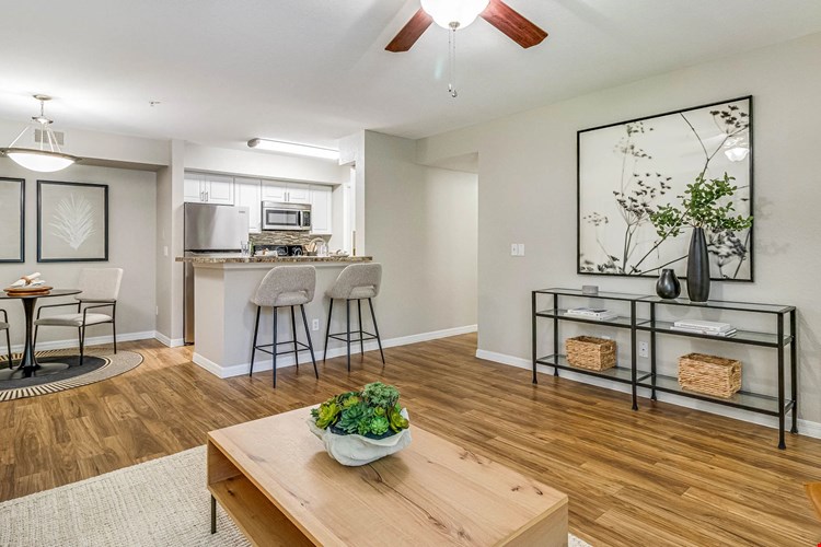 Embrace a spacious, open-concept living exuding timeless elegance with warm wood-like flooring.