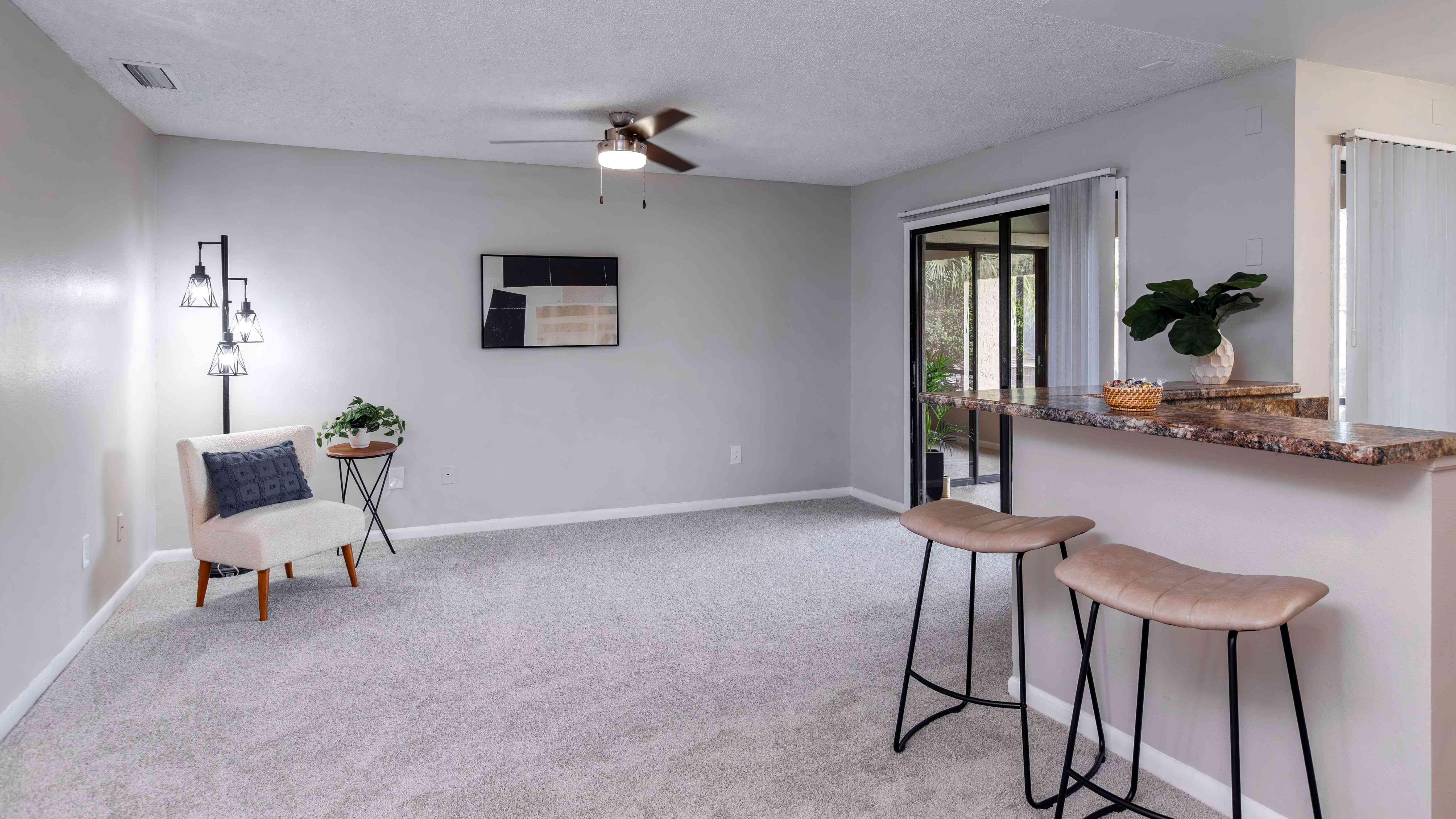 Enjoy the comfort of a spacious, open living featuring plush carpeting, a breakfast bar, and direct access to a screened-in patio.