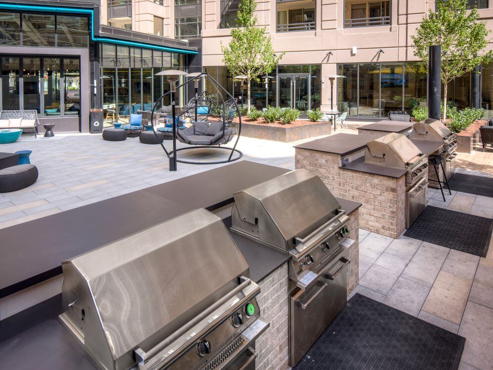 Outdoor chill space with lounge seating, barbecue grills and dining area