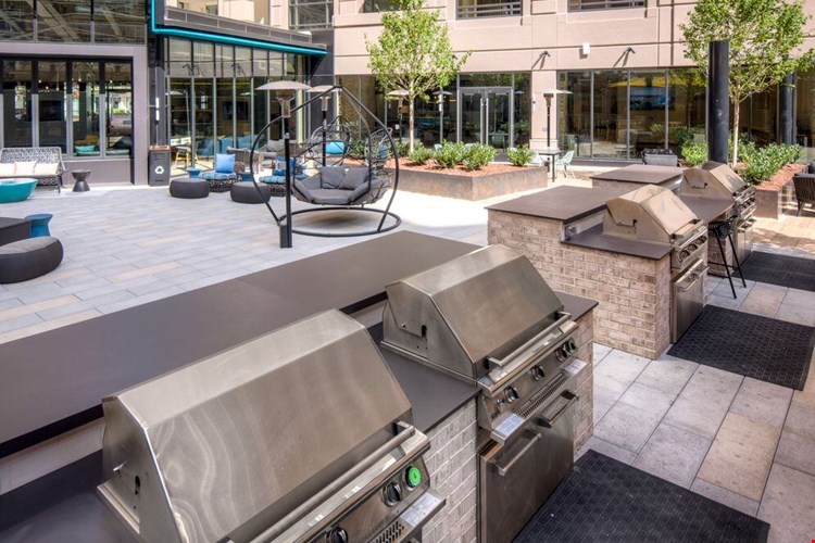 Outdoor chill space with lounge seating, barbecue grills and dining area