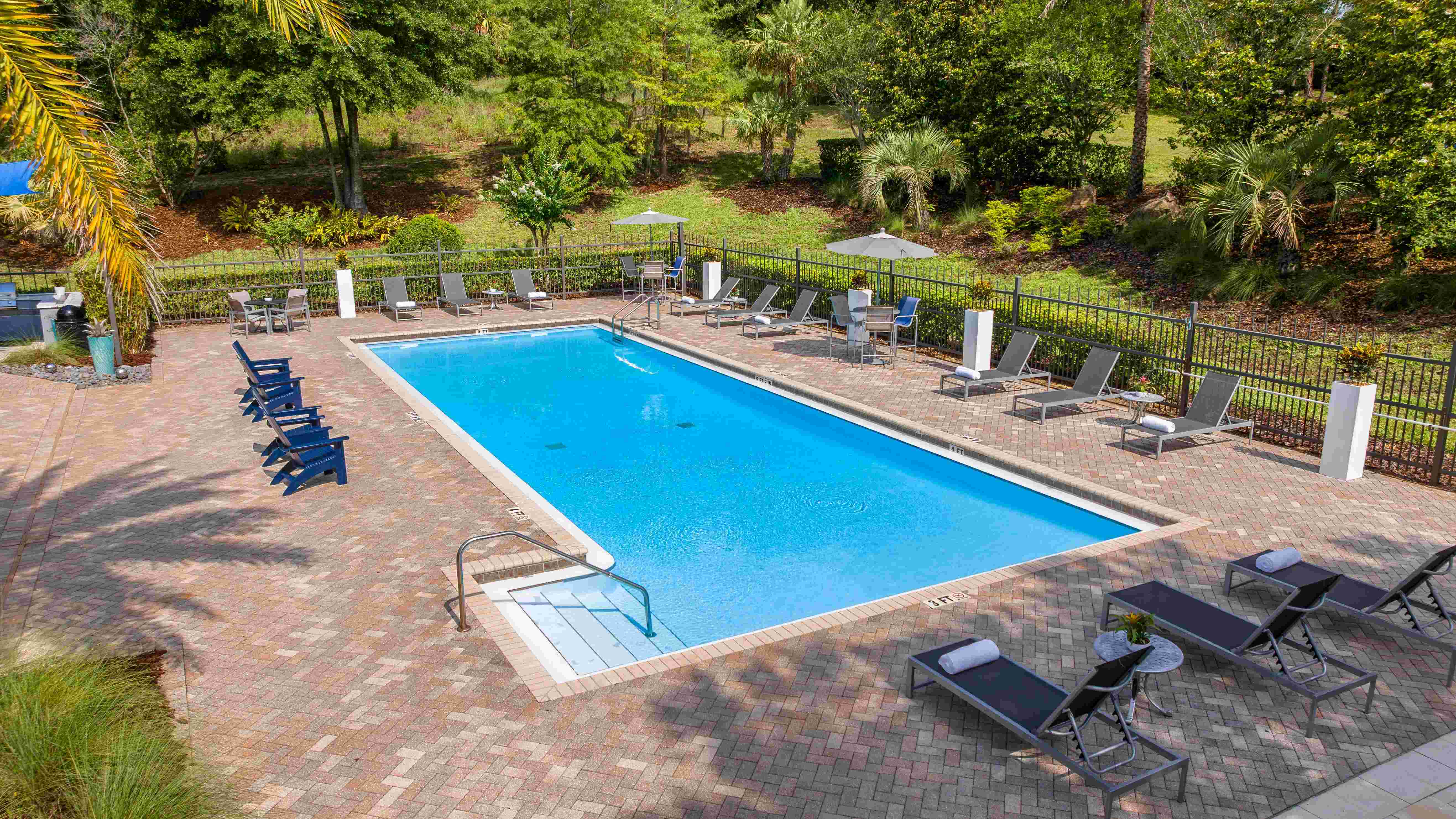 Refresh your day in our serene swimming pool, surrounded by lush greenery and thoughtfully designed outdoor seating areas.