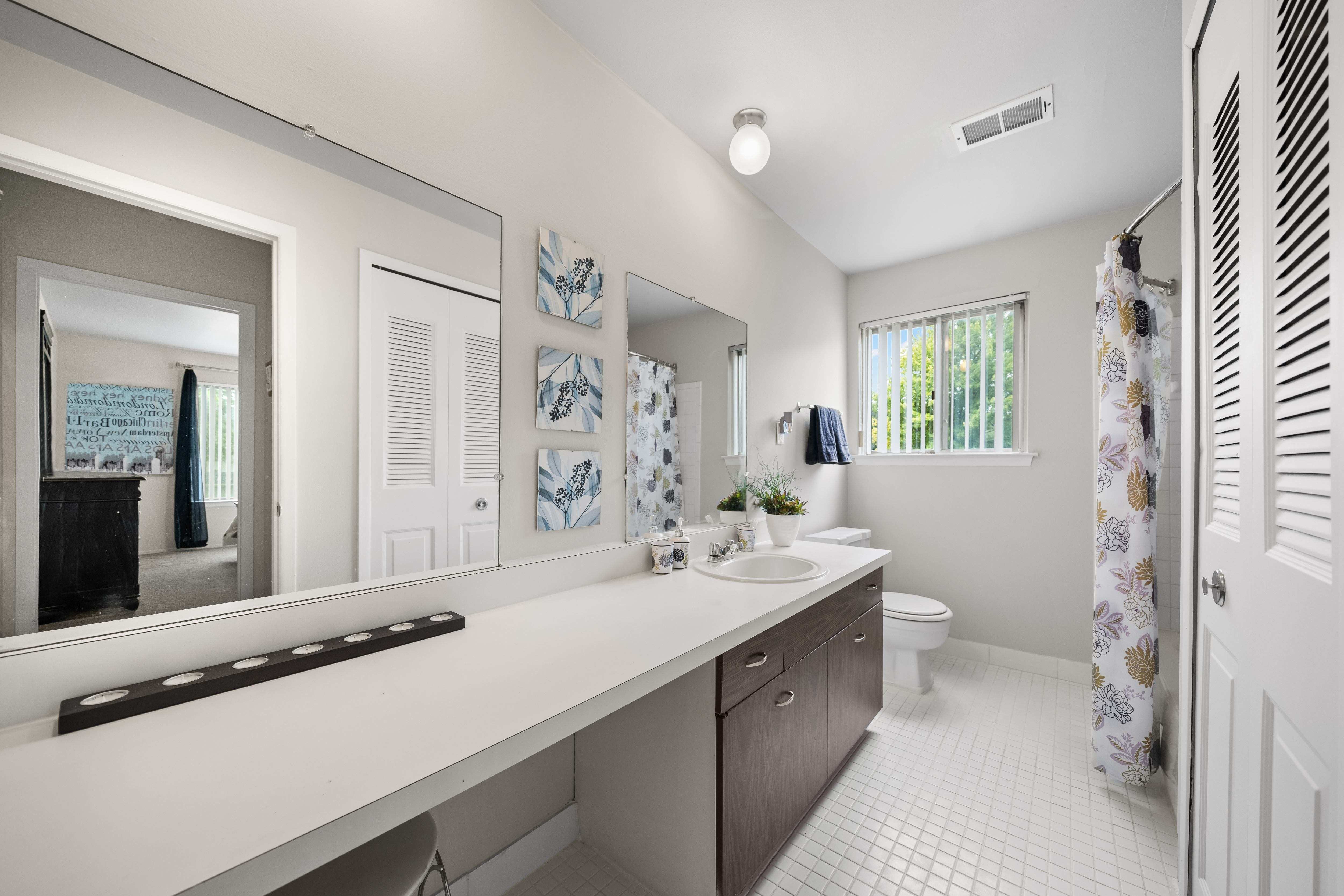 Elevated bathroom with ample storage space at Knottingham Apartments in Clinton Township, MI.