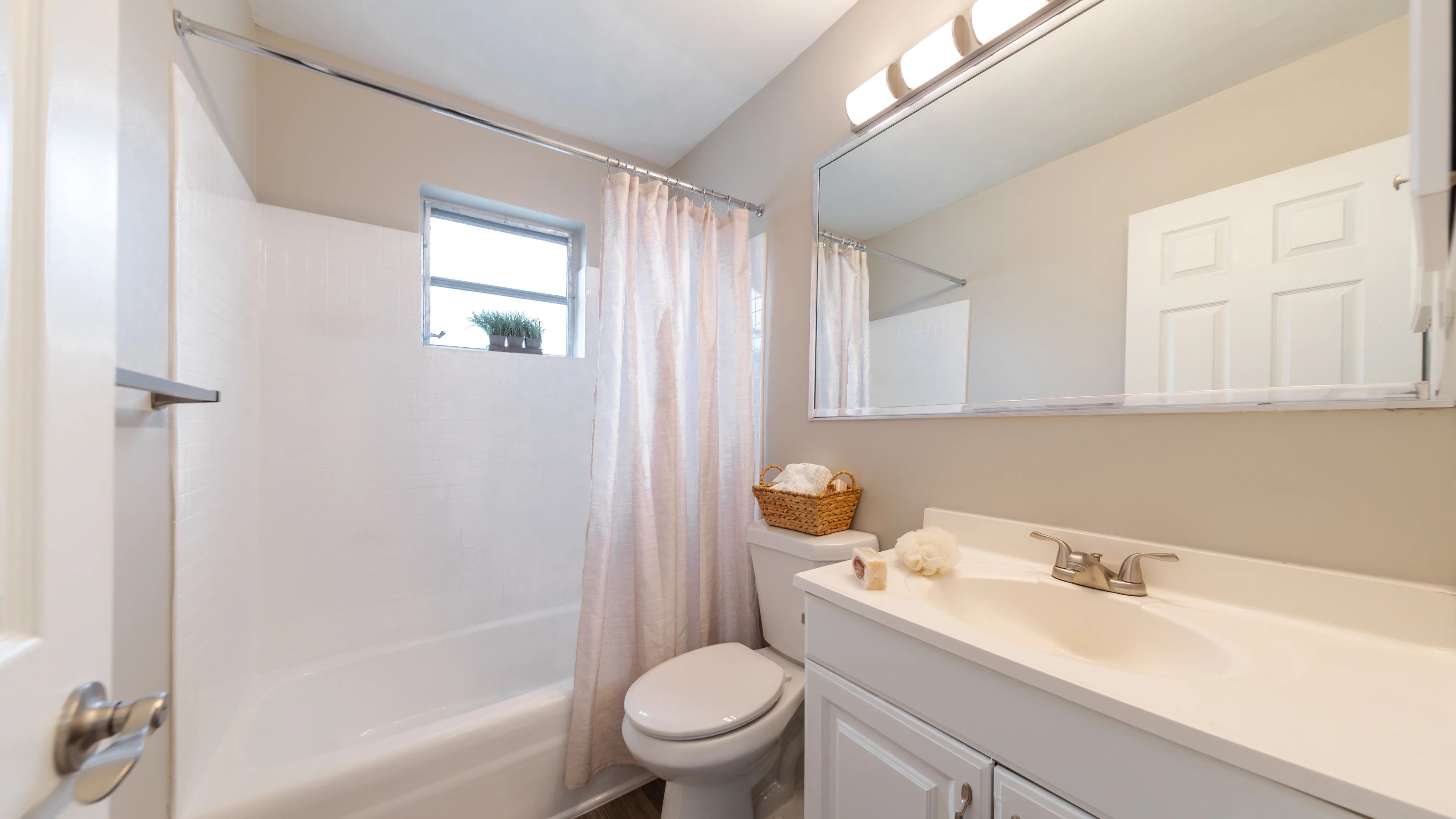 Indulge in bathroom perfection with modern countertops and an expansive mirror.
