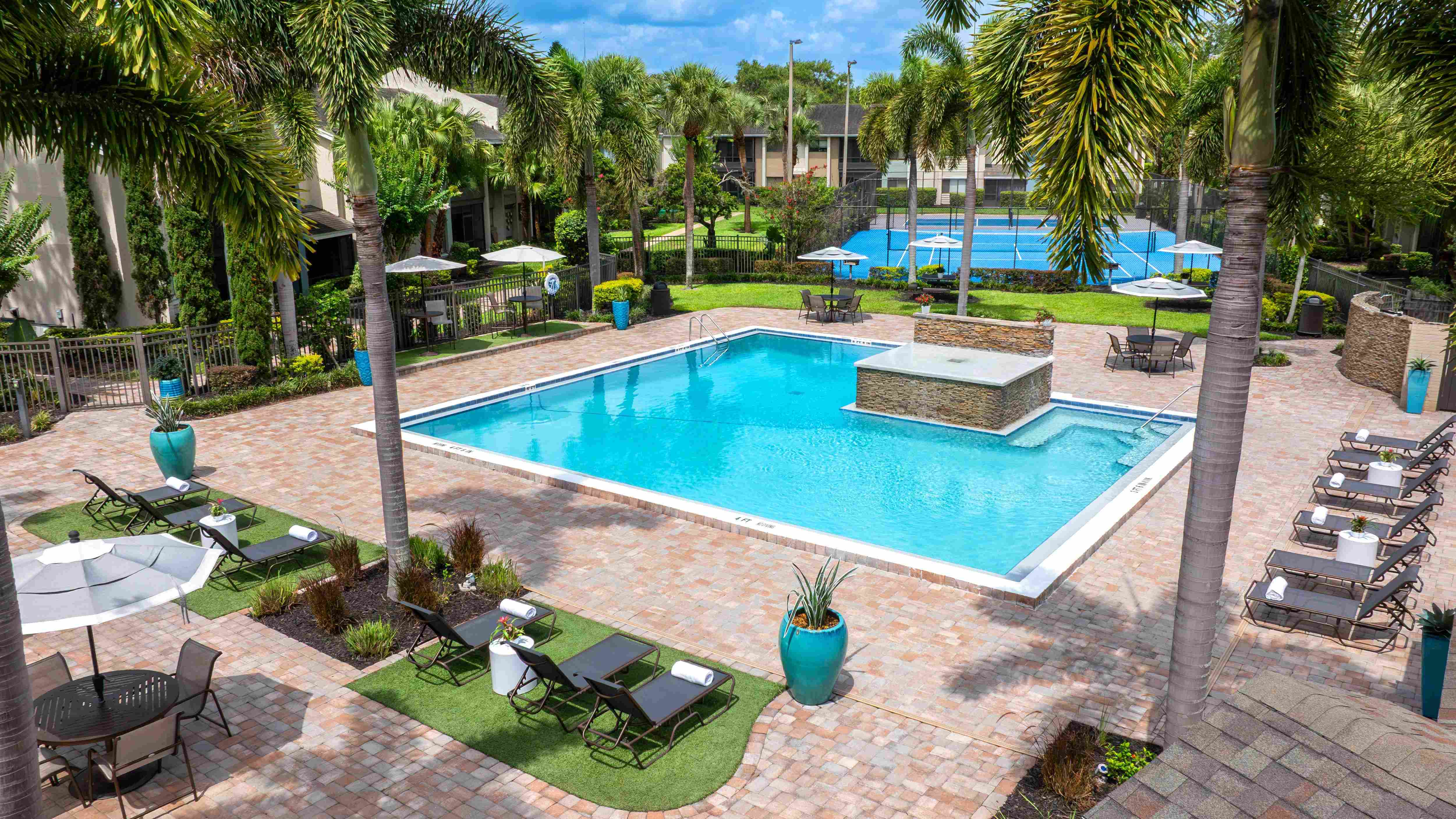 Cool off in style at Harper Grand, where our expansive pool area features a stunning water feature, shaded outdoor dining, and plush loungers.