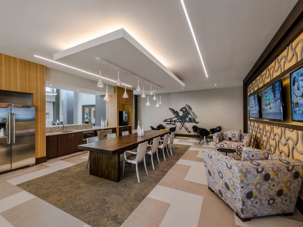 Resident lounge with entertaining kitchen, dining area with seating and flat screen televisions