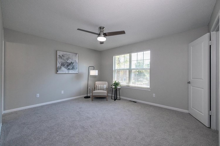 Spacious master bedrooms featuring a ceiling fan and walk-in closet. 