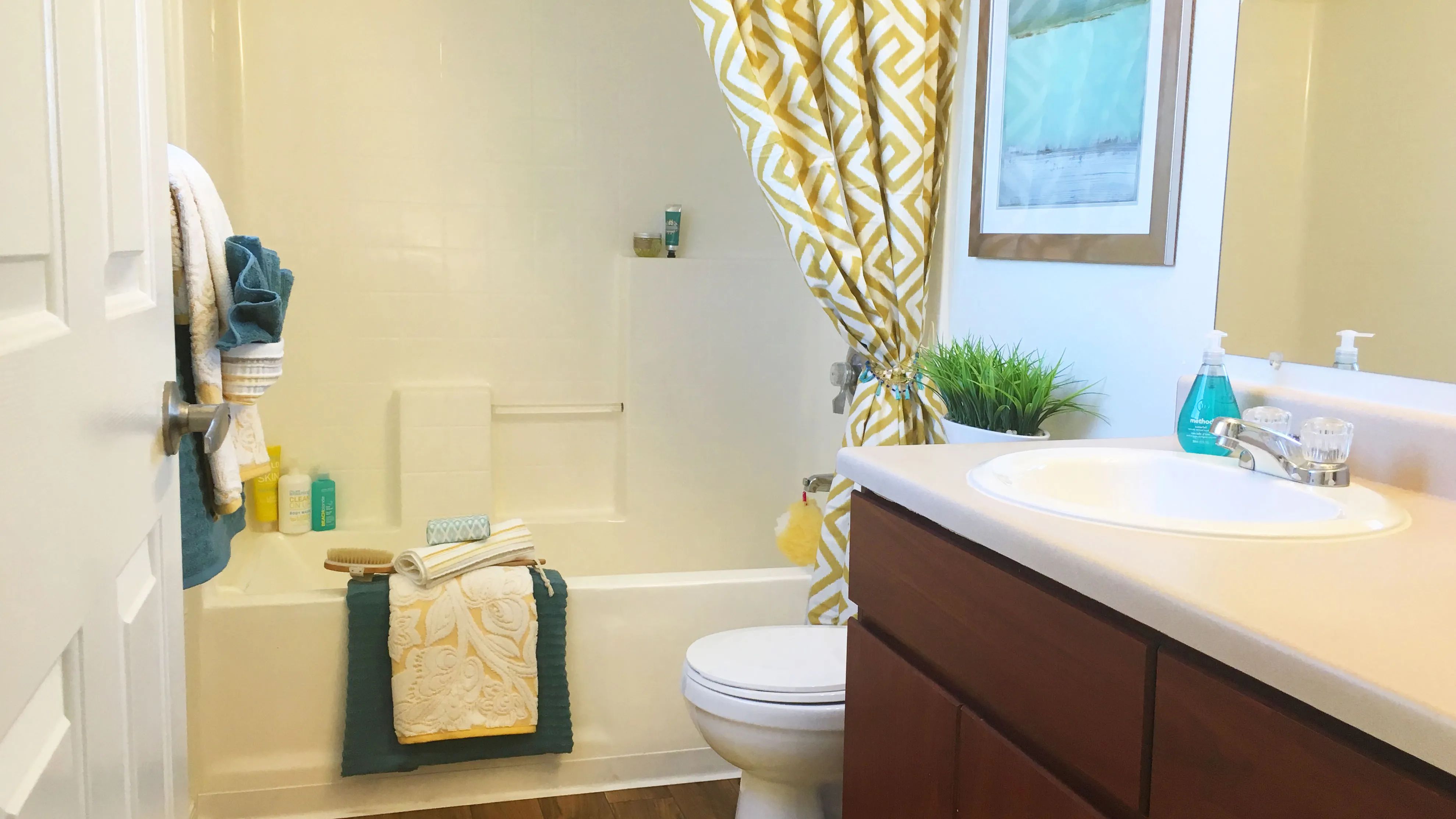 Our bathrooms boast bathing perfection complete with all the essentials for maximum comfort, including a shower/tub combo, a large mirror, and stylish wood-style flooring.