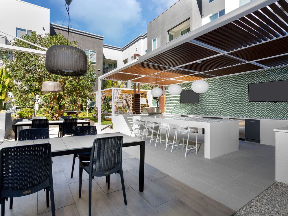 Building B courtyard lounge with outdoor entertaining kitchen and seating