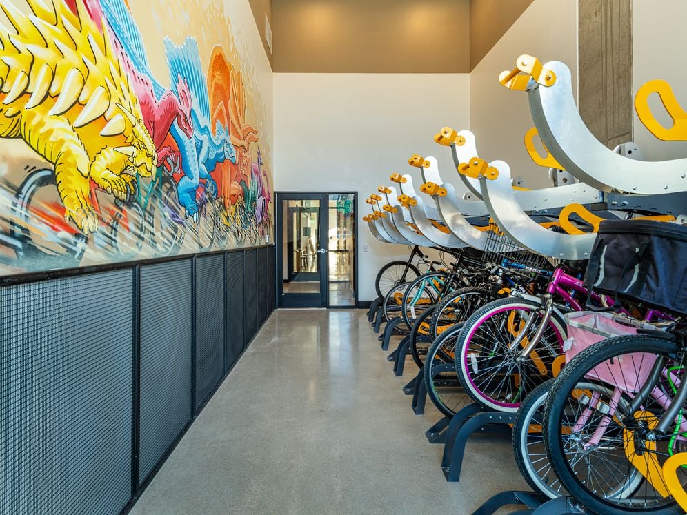 Bike room with mural art by Drew Button