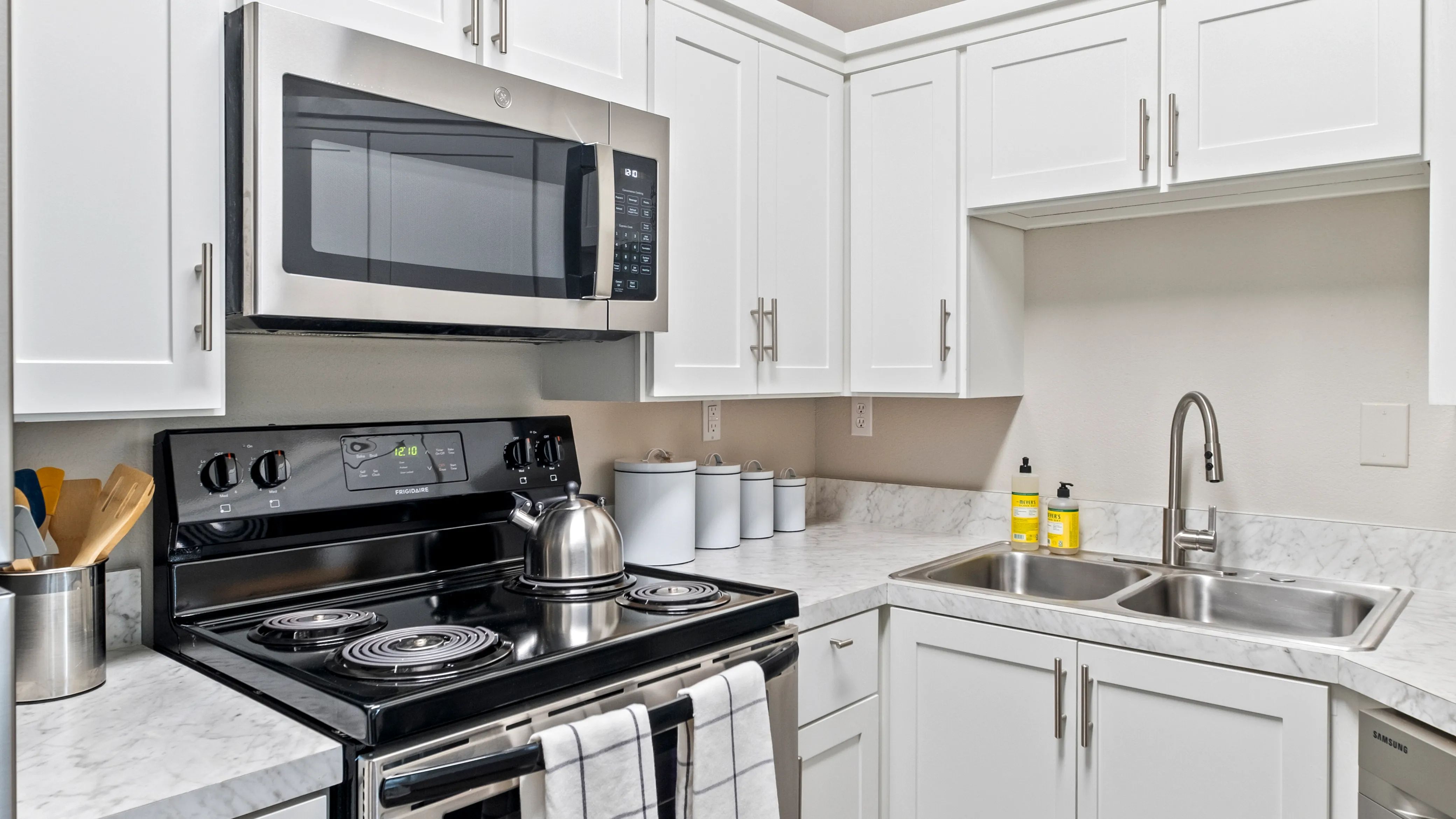 This brilliantly upgraded kitchen will serenade your senses. Capture the luminous allure as it dances off the white cabinets and glistening stainless-steel appliances. 