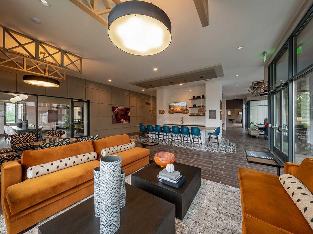 East building resident lounge with entertaining kitchen, lounge seating, and flat screen television