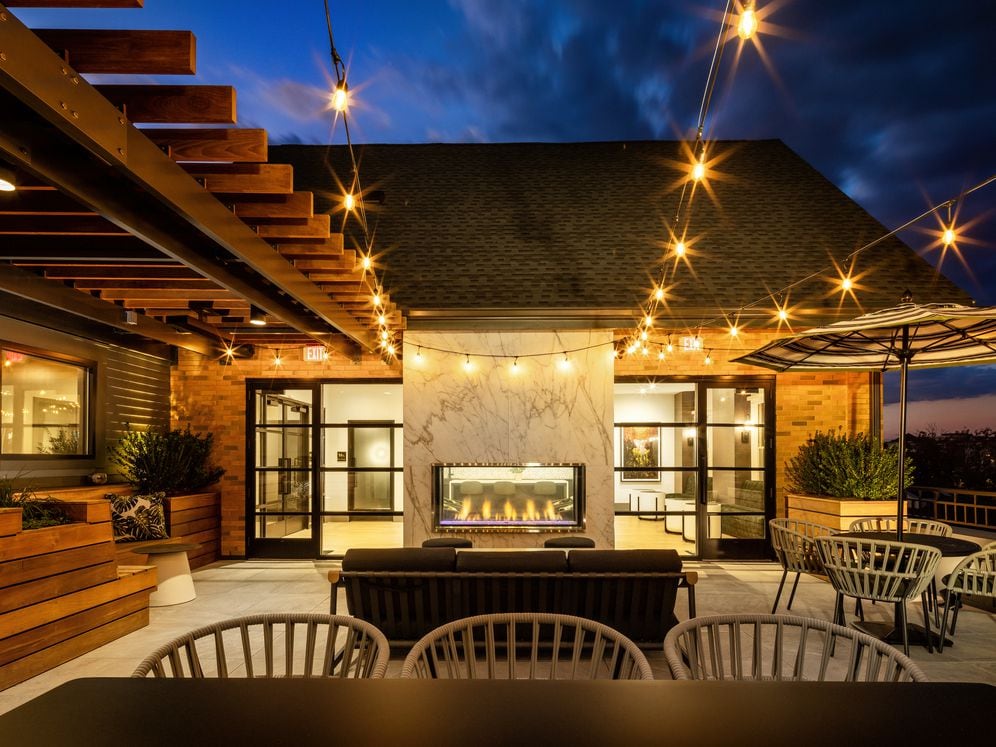 North Building Roof deck with lounge seating, fireplace, and grills