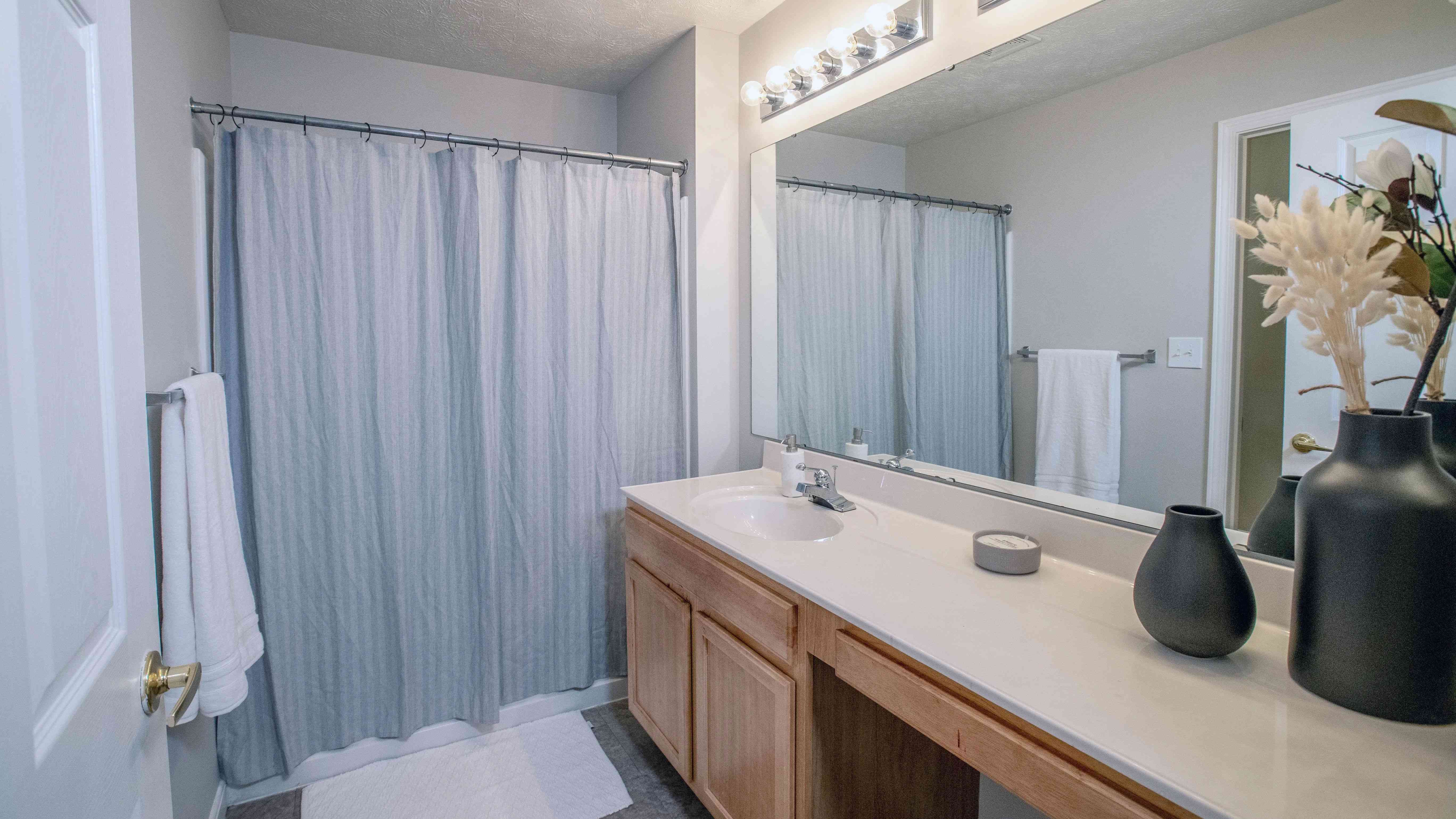 Primary bathrooms offer a lavish vanity area with dual lighting and a delightfully oversized mirror, preparing you for the day. 