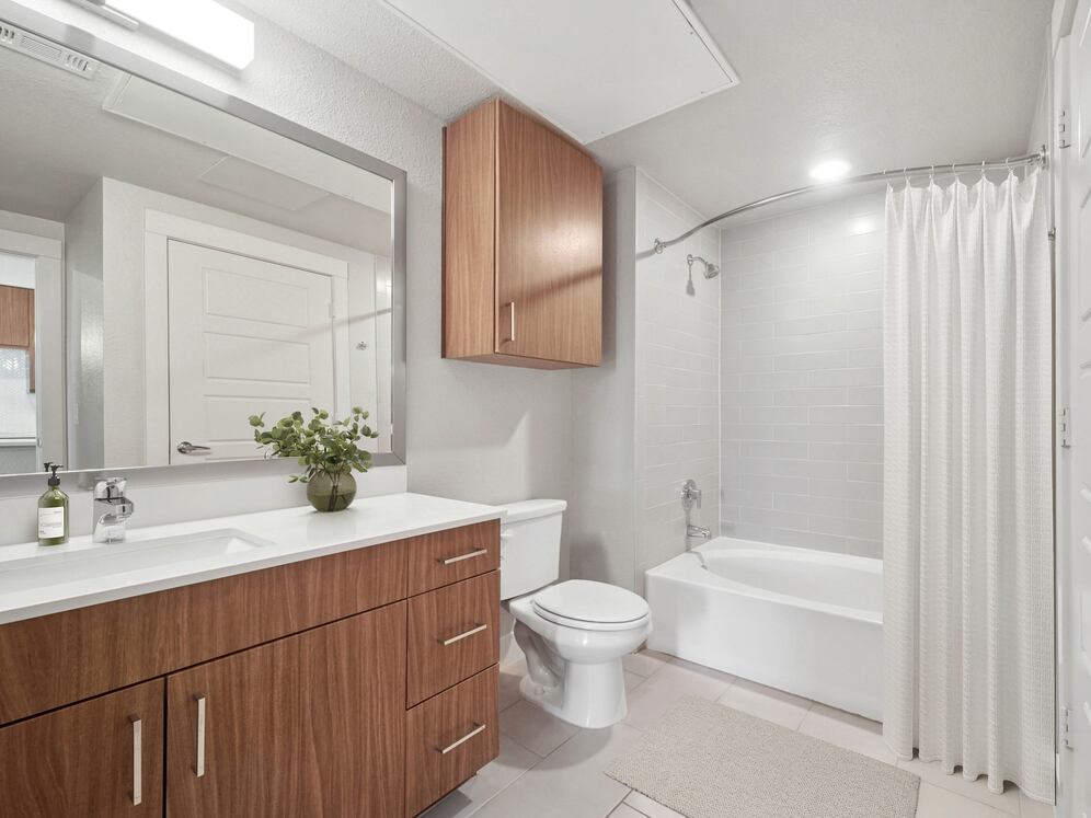 Finish Package I bath with white quartz countertops and dark cabinetry