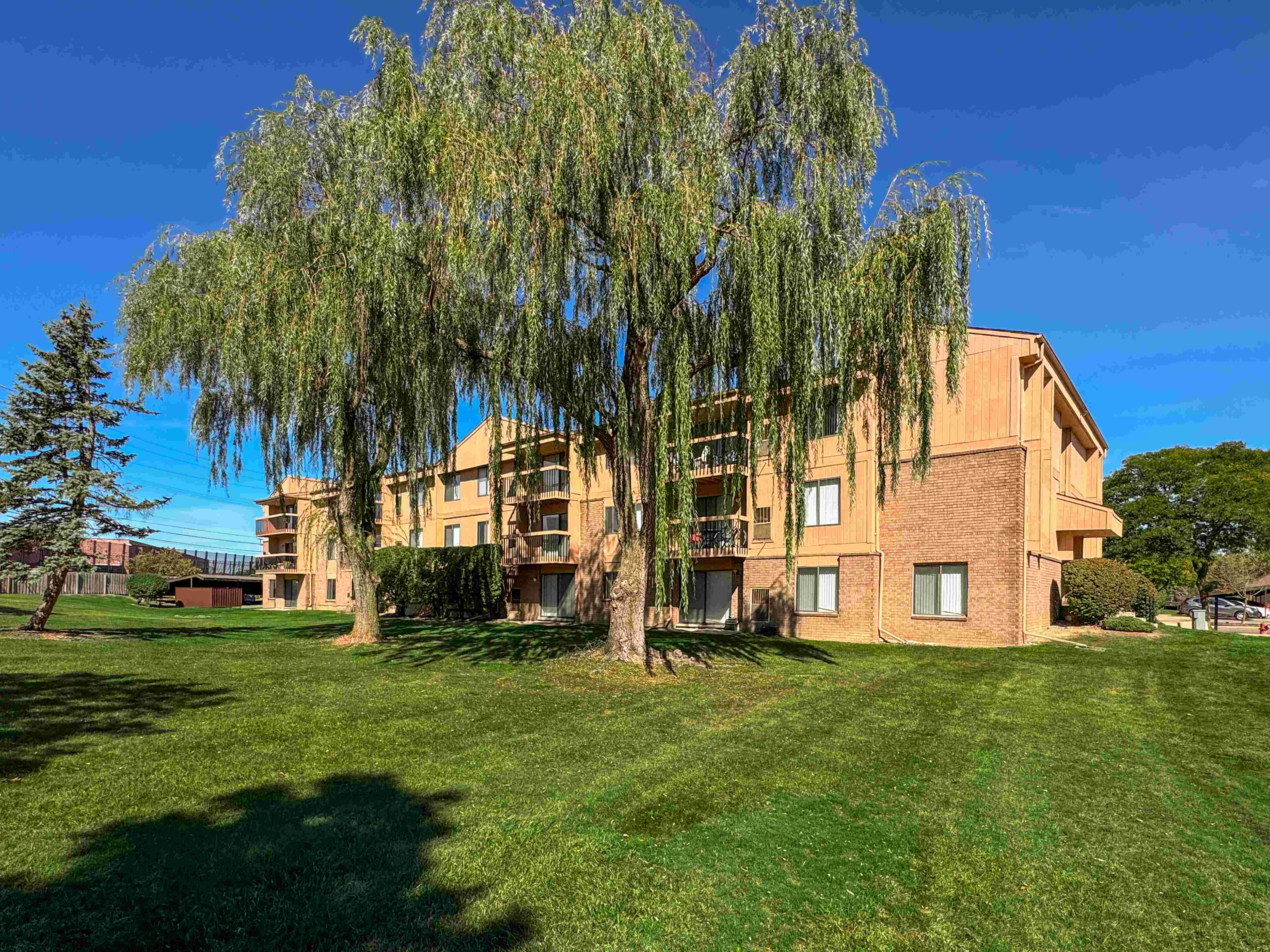 Expansive Green Space Apartment Building Exterior at Franklin River Apartments, Southfield, MI