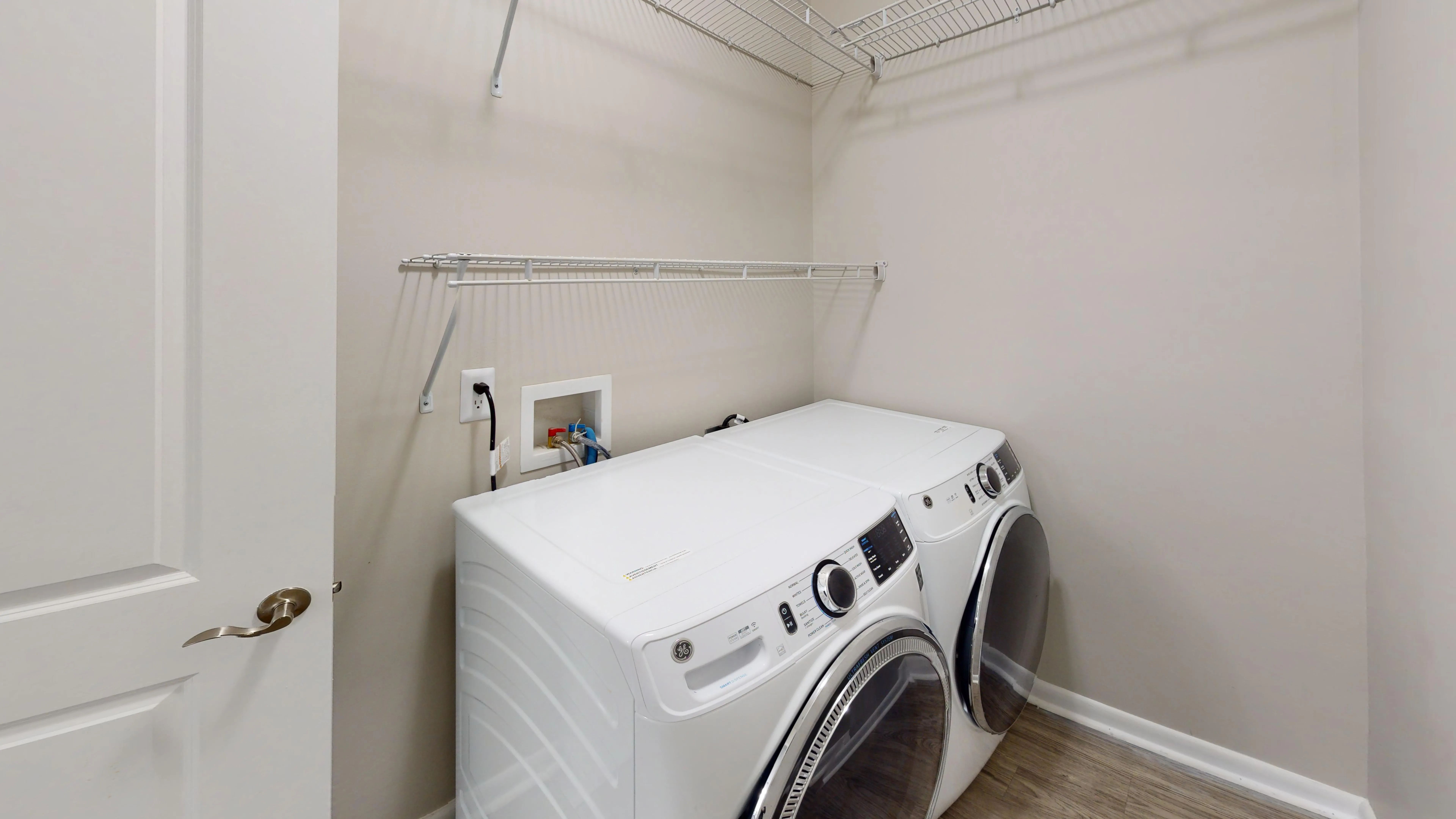Enjoy the convenience of a dedicated laundry room in The Rosewood floor featuring a full-size washer and dryer, and built-in wire shelving.