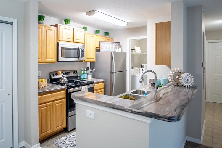 Embrace open-concept living at Eagle's Pointe, where the breakfast bar delightfully opens to the living area.