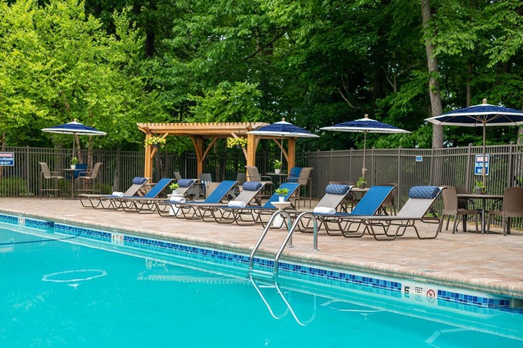 Our pool area features plenty of seating options including loungers and tables with umbrellas.