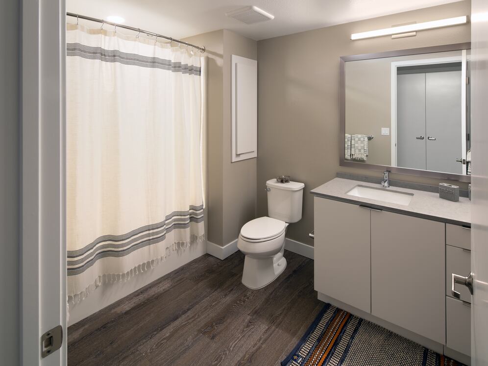 Bath with quartz countertop and hard surface flooring