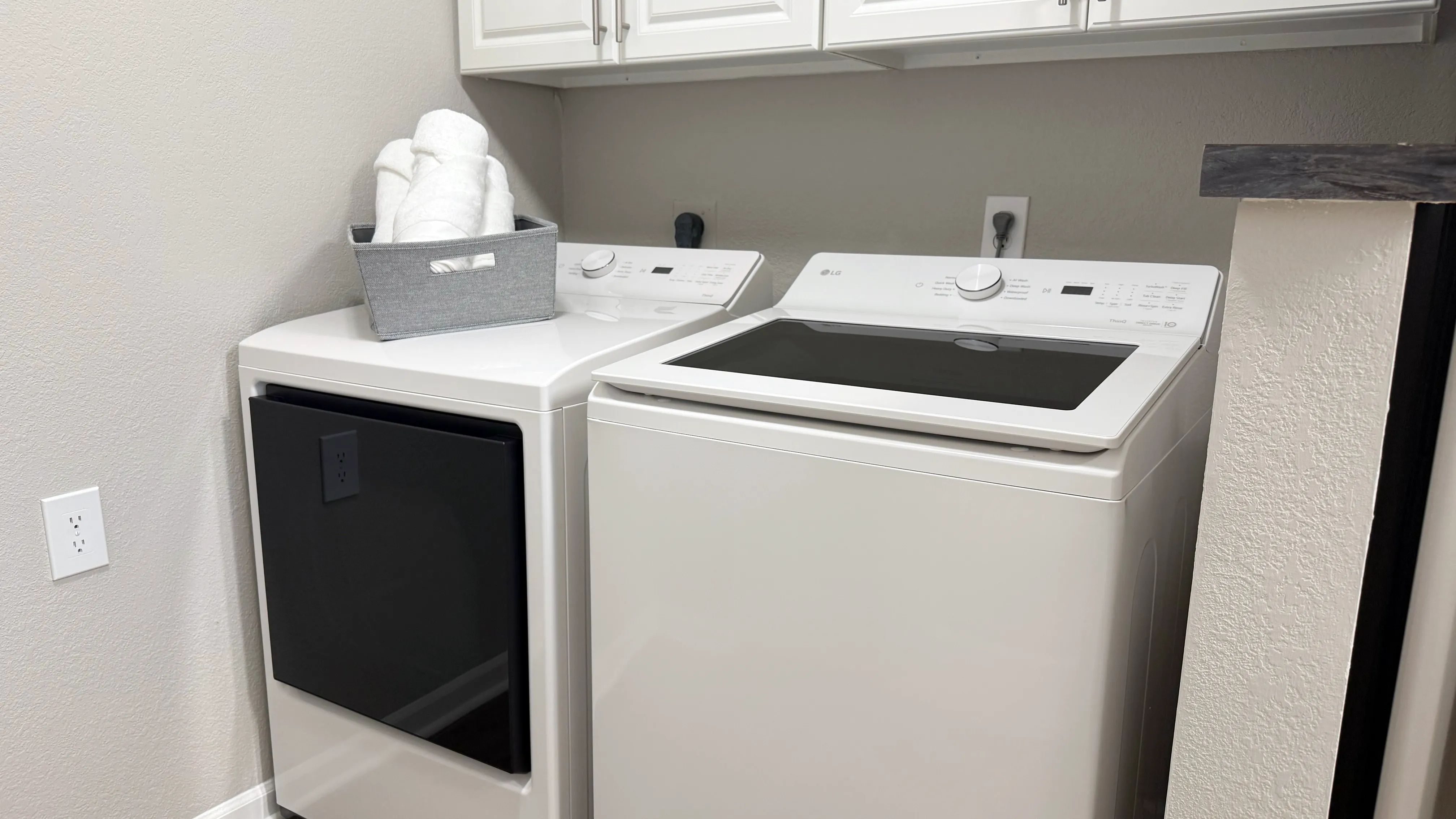 Thoughtfully integrated into the apartment layout, this dedicated laundry area features full-size washer and dryer appliances and additional overhead storage.