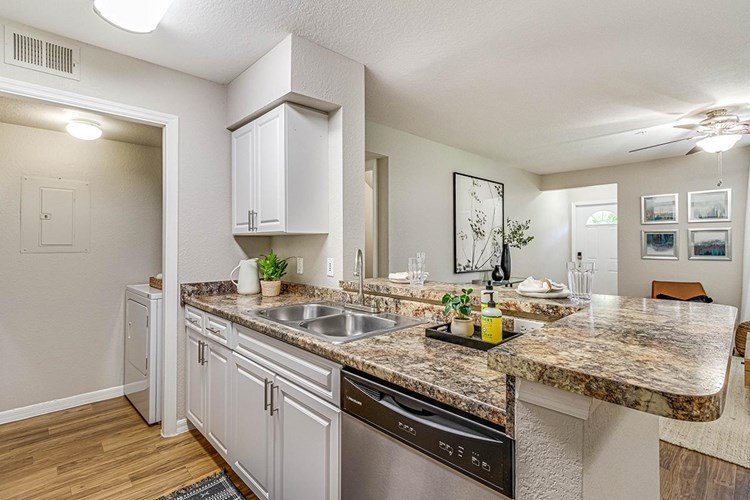 Contemporary kitchens with breakfast bars, ideal for casual dining or entertaining. Laundry room is located next to the kitchen.