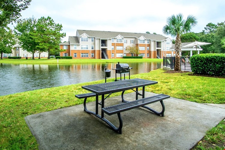 Relax and unwind at the serene picnic area at Eagles Pointe Apartments. Overlooking a peaceful lake, this spot features convenient grills and seating, perfect for enjoying outdoor meals and gatherings.