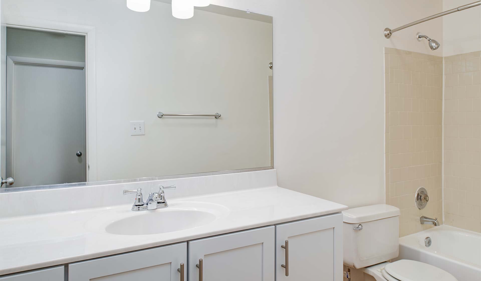 Bathroom has a large vanity for extra storage