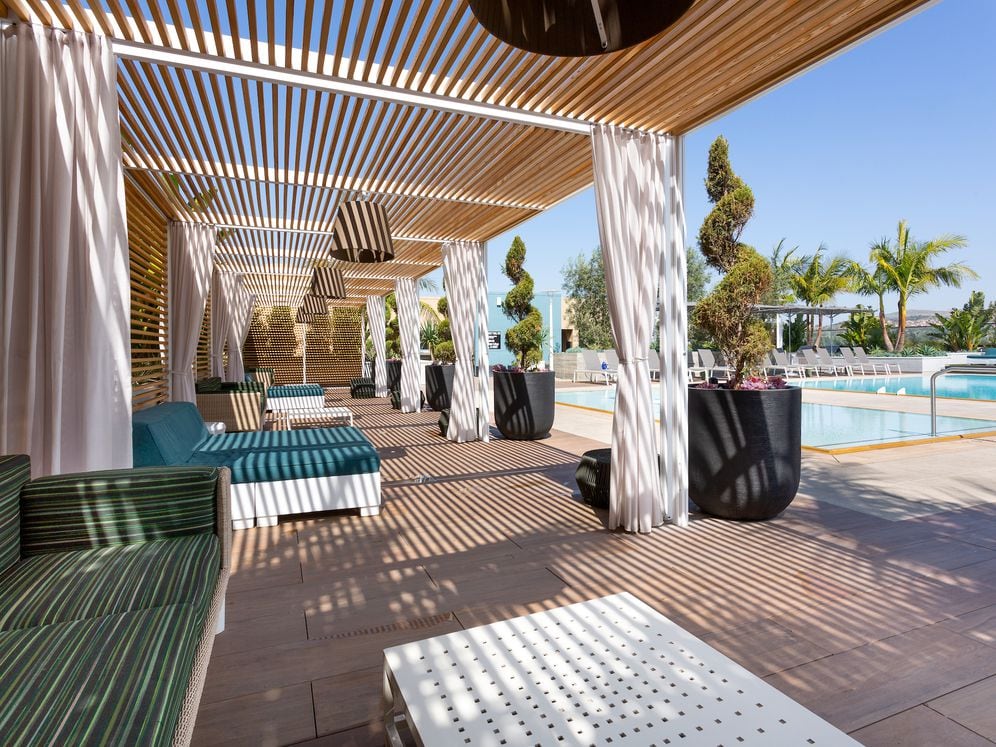 Building A rooftop pool with cabanas and lounge seating