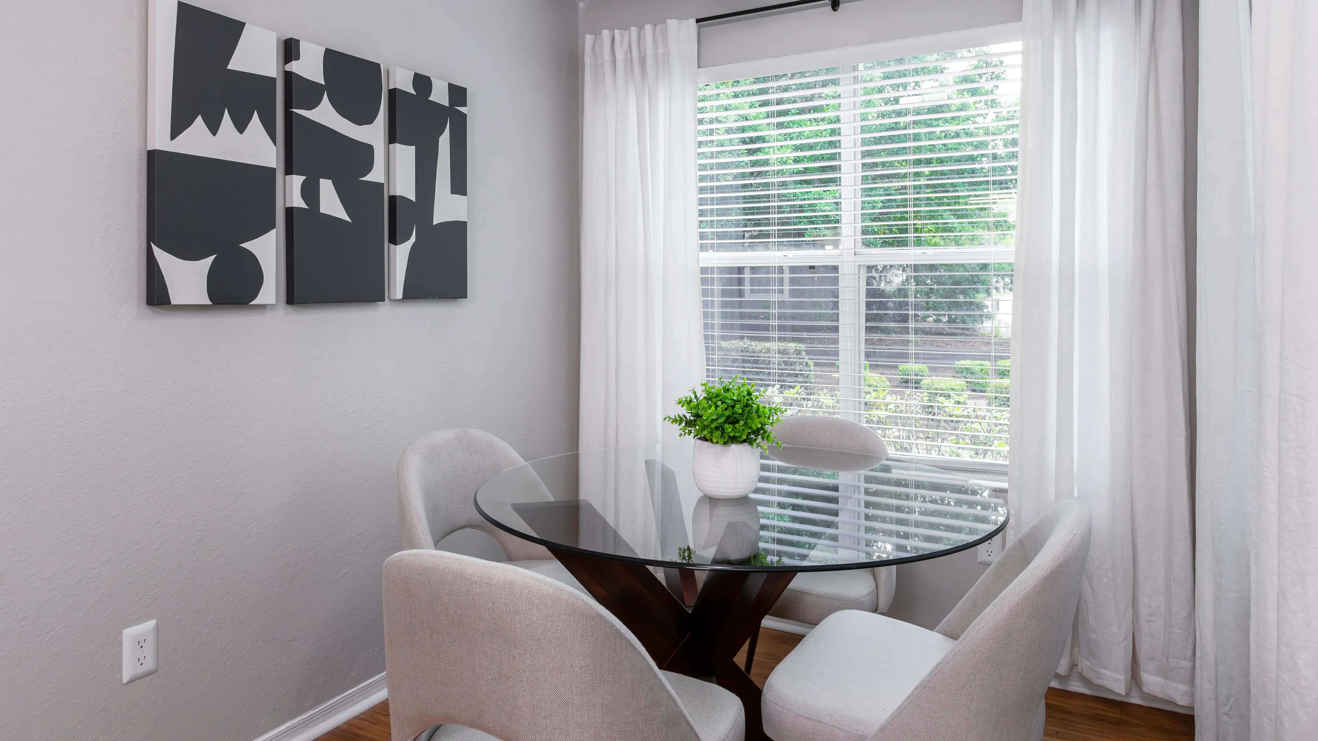 Drenched in natural light, this charming solarium creates the perfect corner for casual meals, coffee chats, or a quiet morning read.