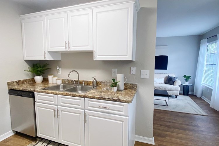 Updated kitchens also feature white cabinetry and wood-style flooring.